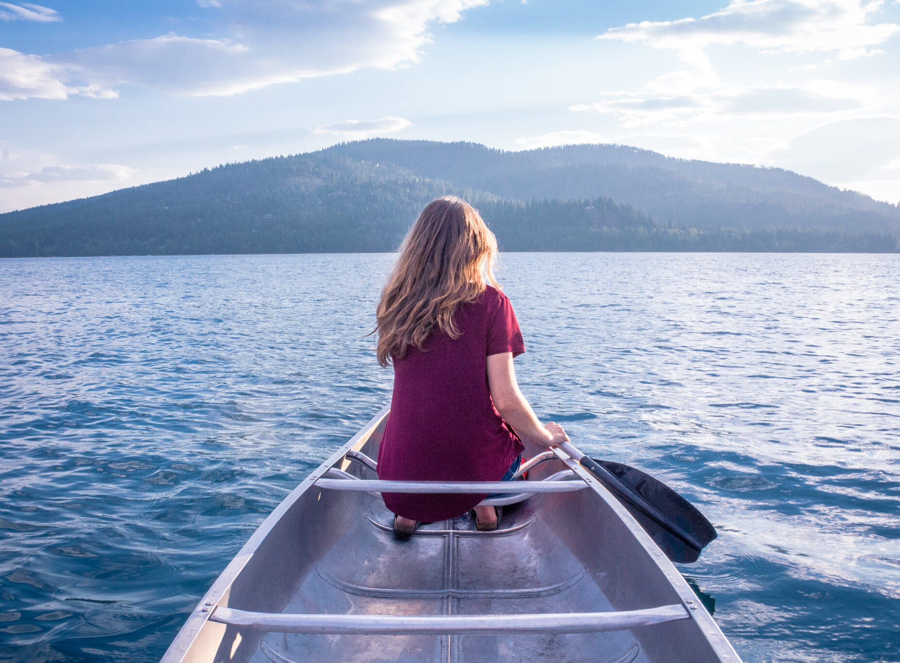 Canoeing on Whitefish Lake, Montana with Mountains in the distance