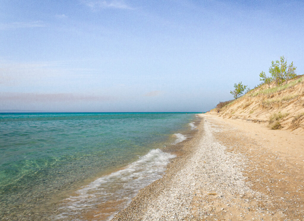 Beachscape and sand dunes with crystal clear water at the Dune Climb Hike in the Sleeping Bear Dunes National Lakeshore near Traverse City
