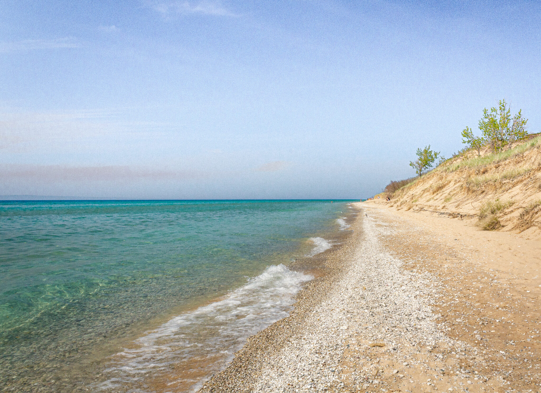 Beachscape and sand dunes with crystal clear water at the Dune Climb Hike in the Sleeping Bear Dunes National Lakeshore near Traverse City