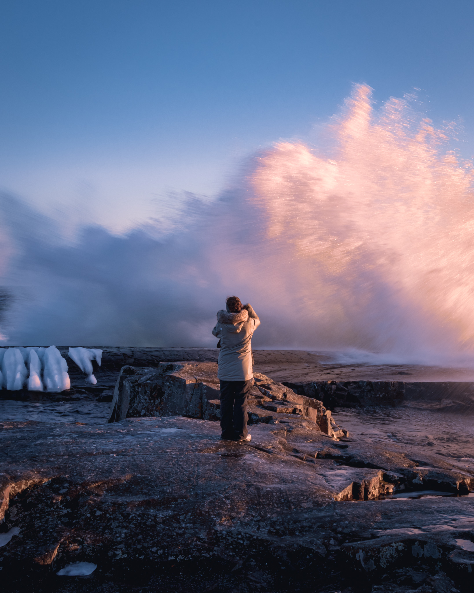 A large wave Lake Superior crashes into the Grand Marais Breakwater