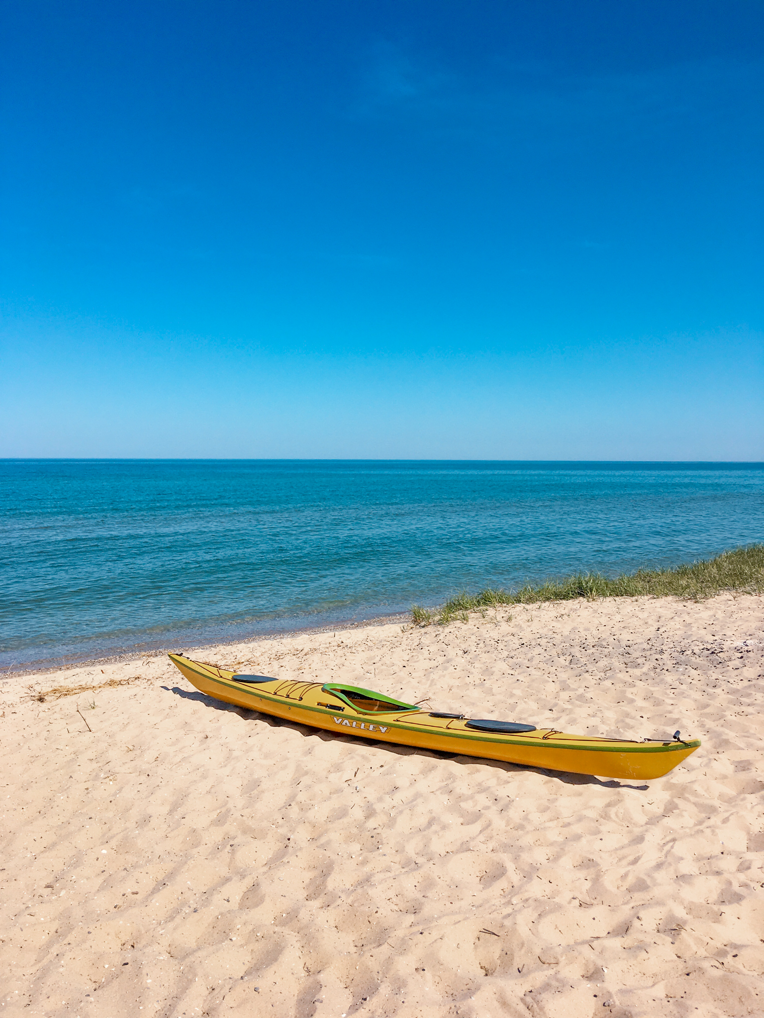 A sea kayak on a beach near Traverse City