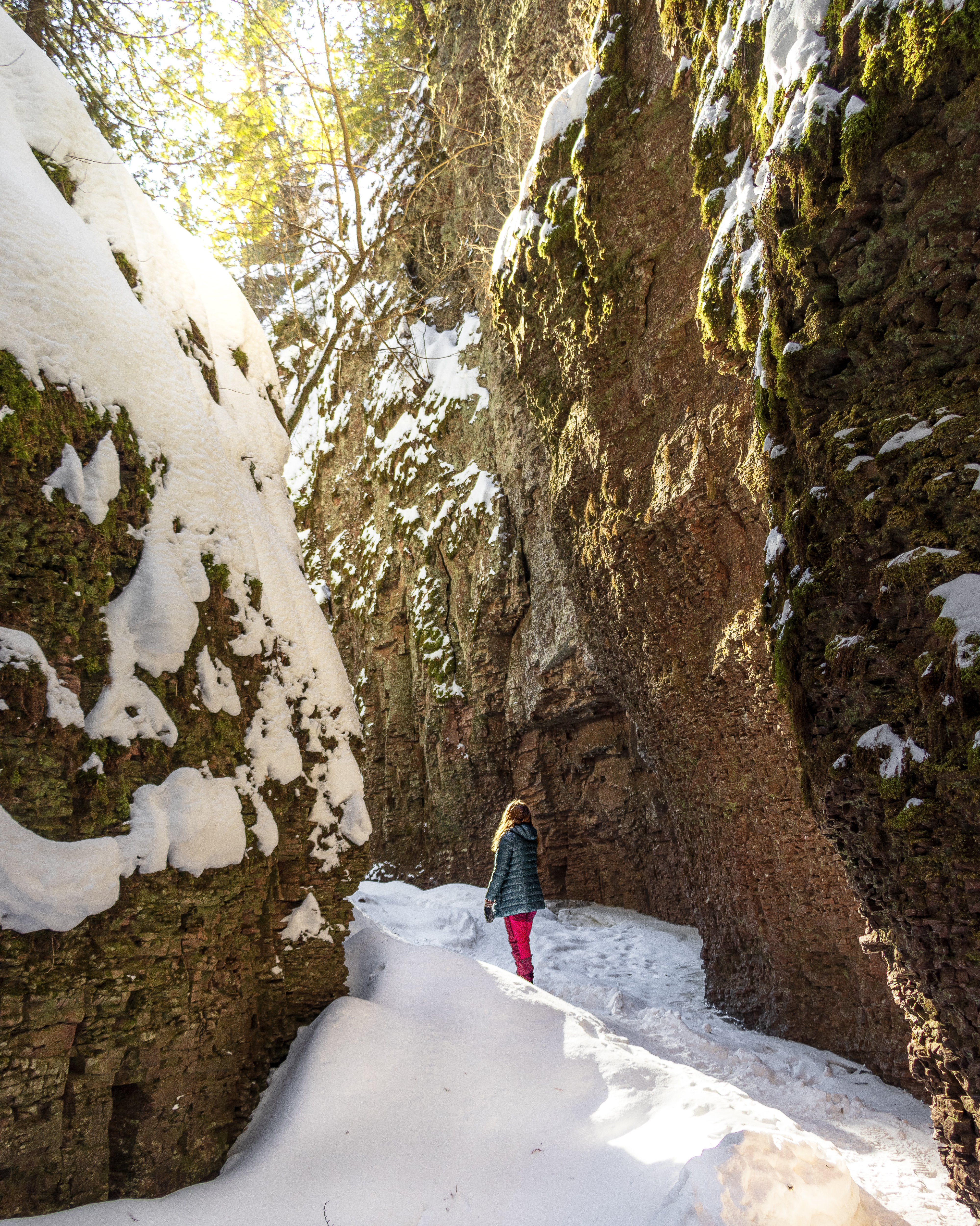 a hiker stands in a snowy canyon in Northern Minnesota