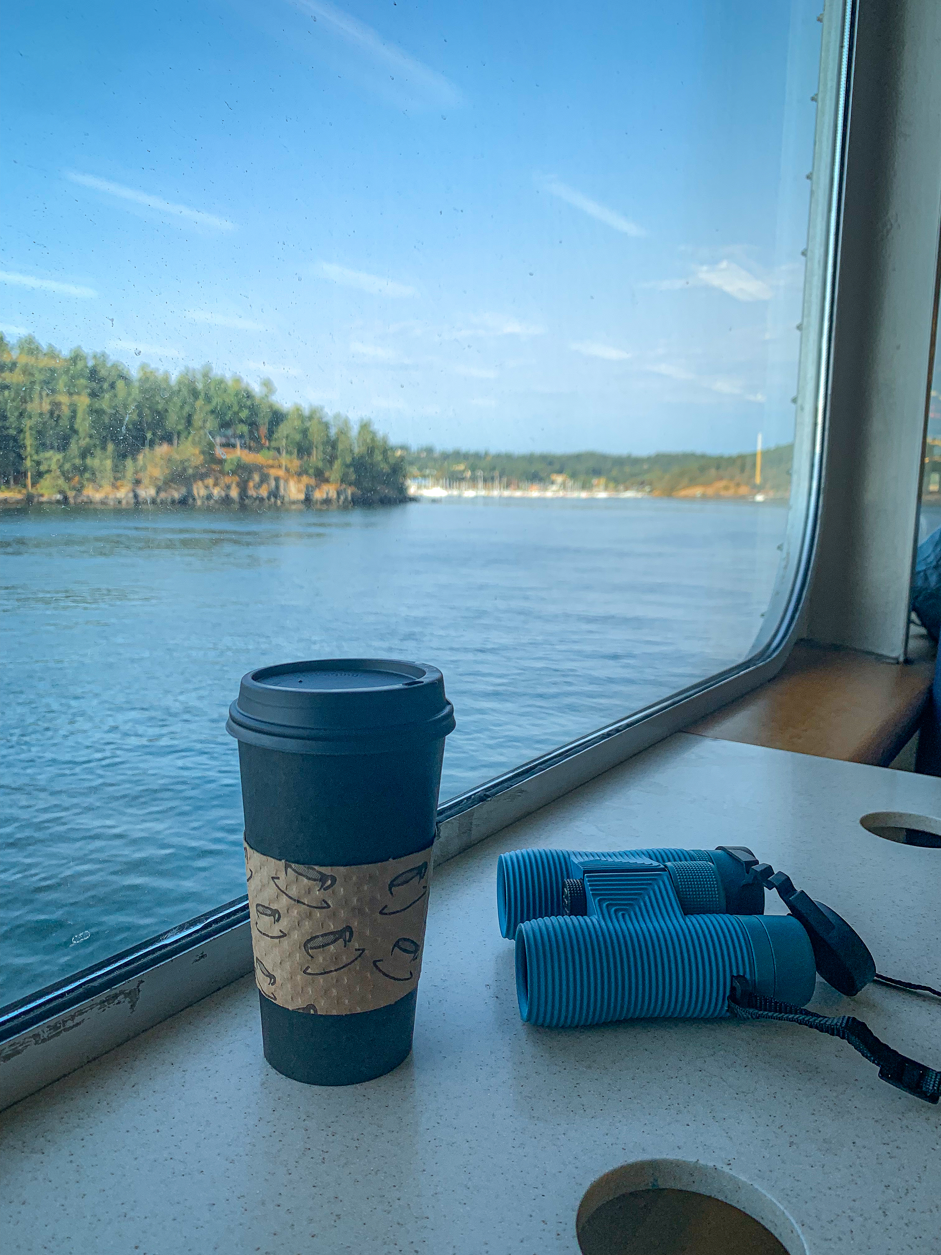 image of coffee and binoculars on the washington state ferry headed to friday harbor