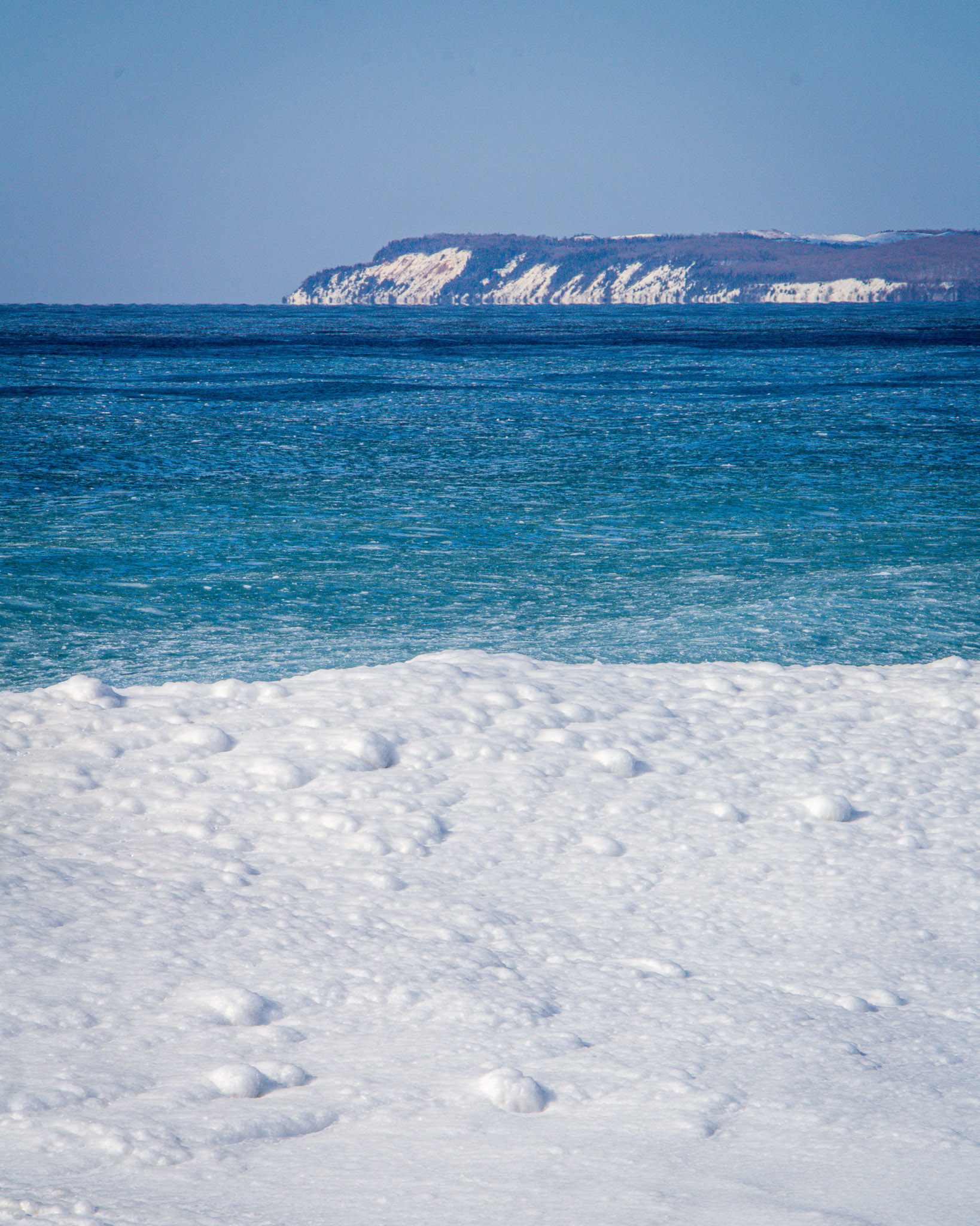Image of the snowy Manitous Islands in the Sleeping Bear Dunes National Lakeshore from Dune Climb looking out over the Manitou Passage on Lake Michigan