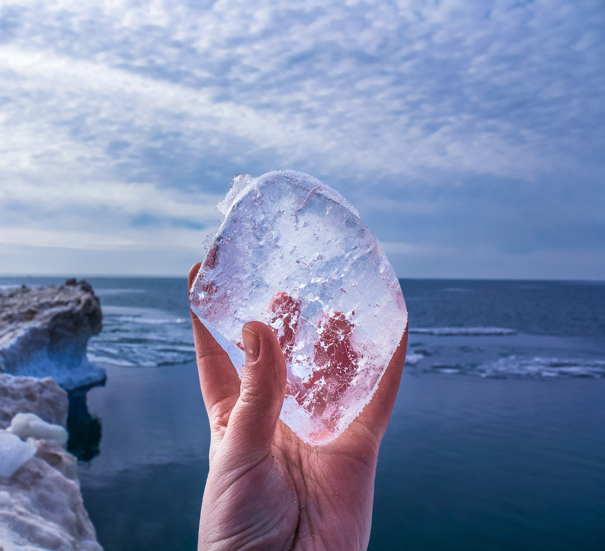 A frozen piece of ice held over a cold Lake Michigan near Saugatuck, Michigan