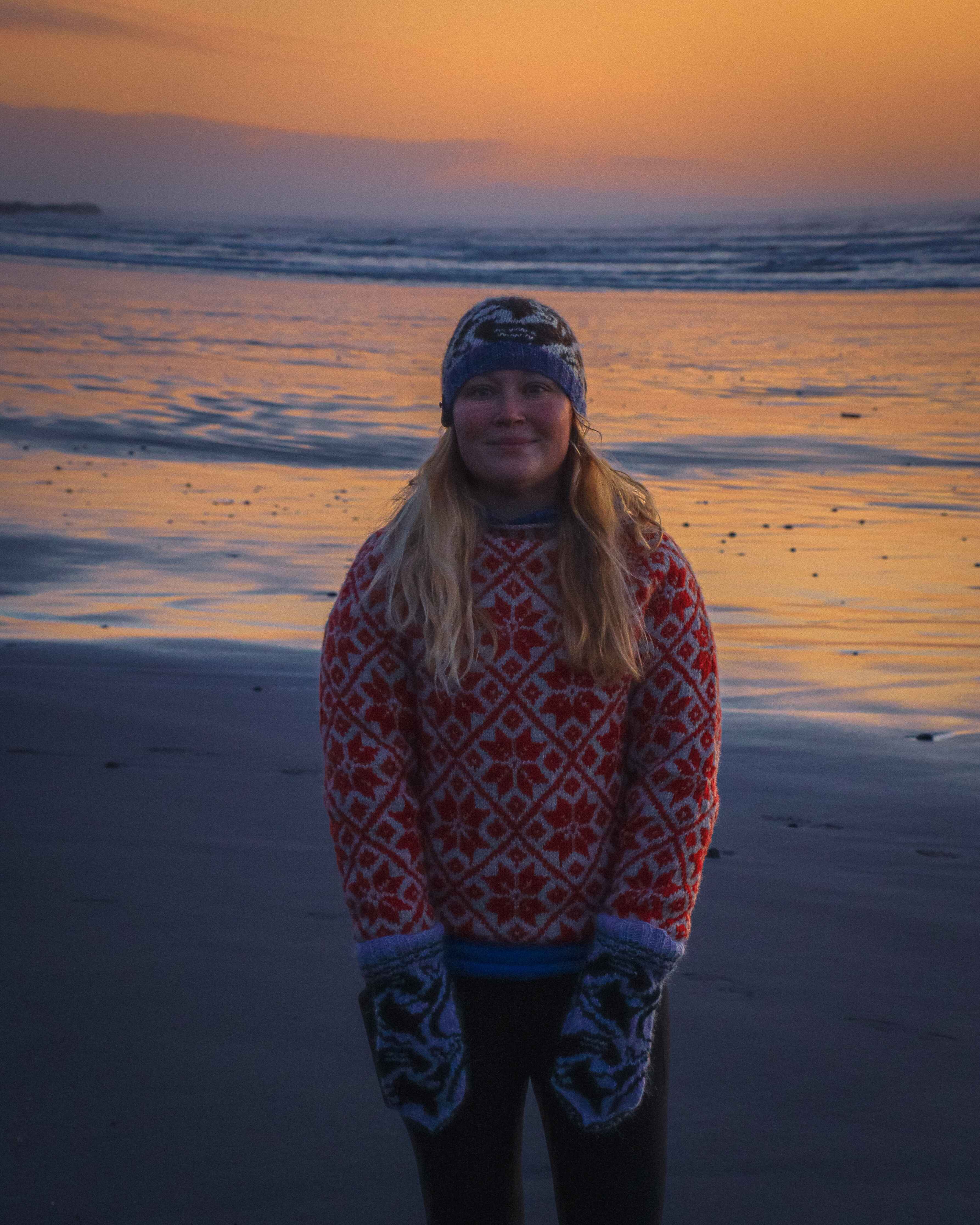 A woman smiles on a beach in Olympic National Park
