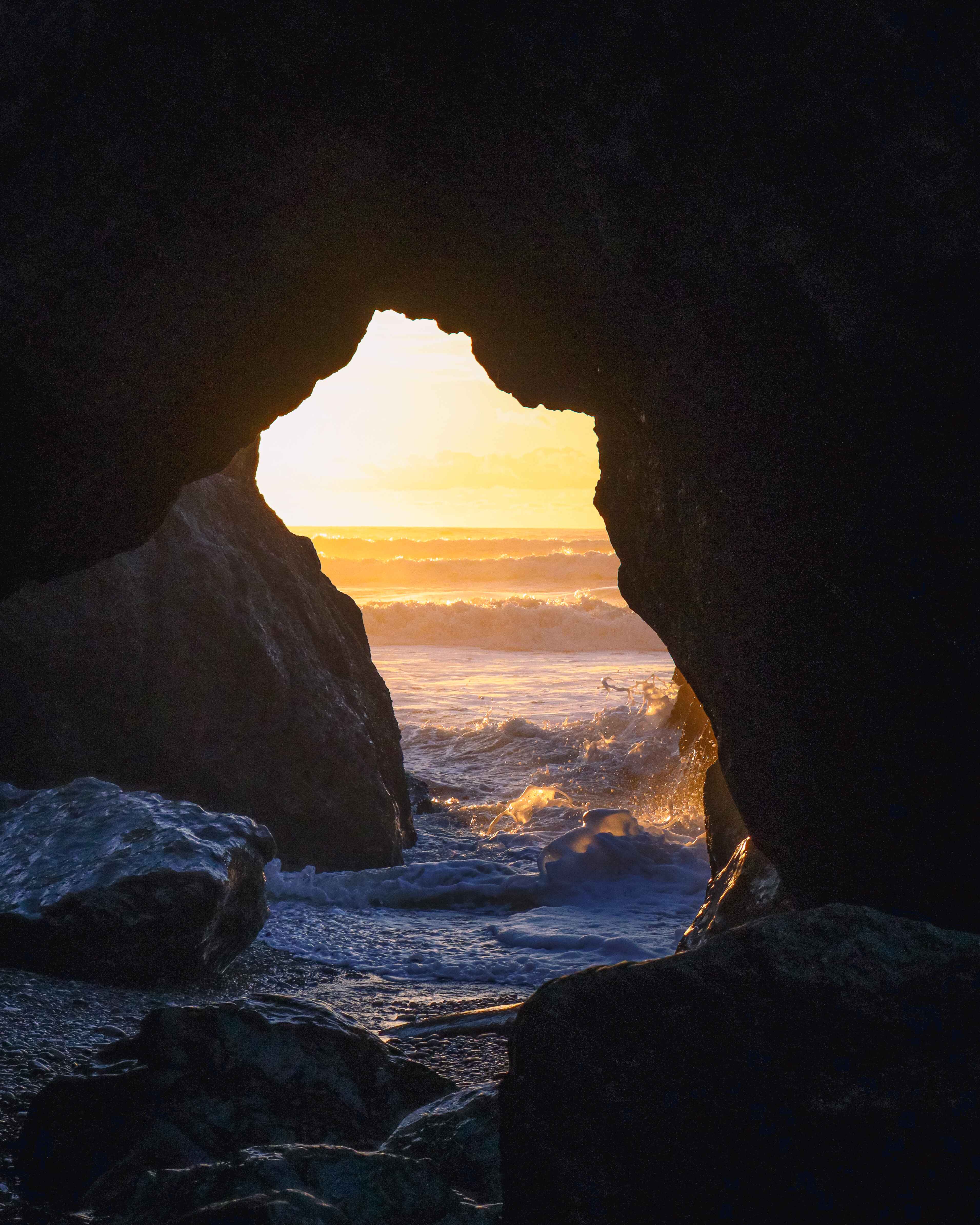 a low tide sea arch in olympic national park at sunset