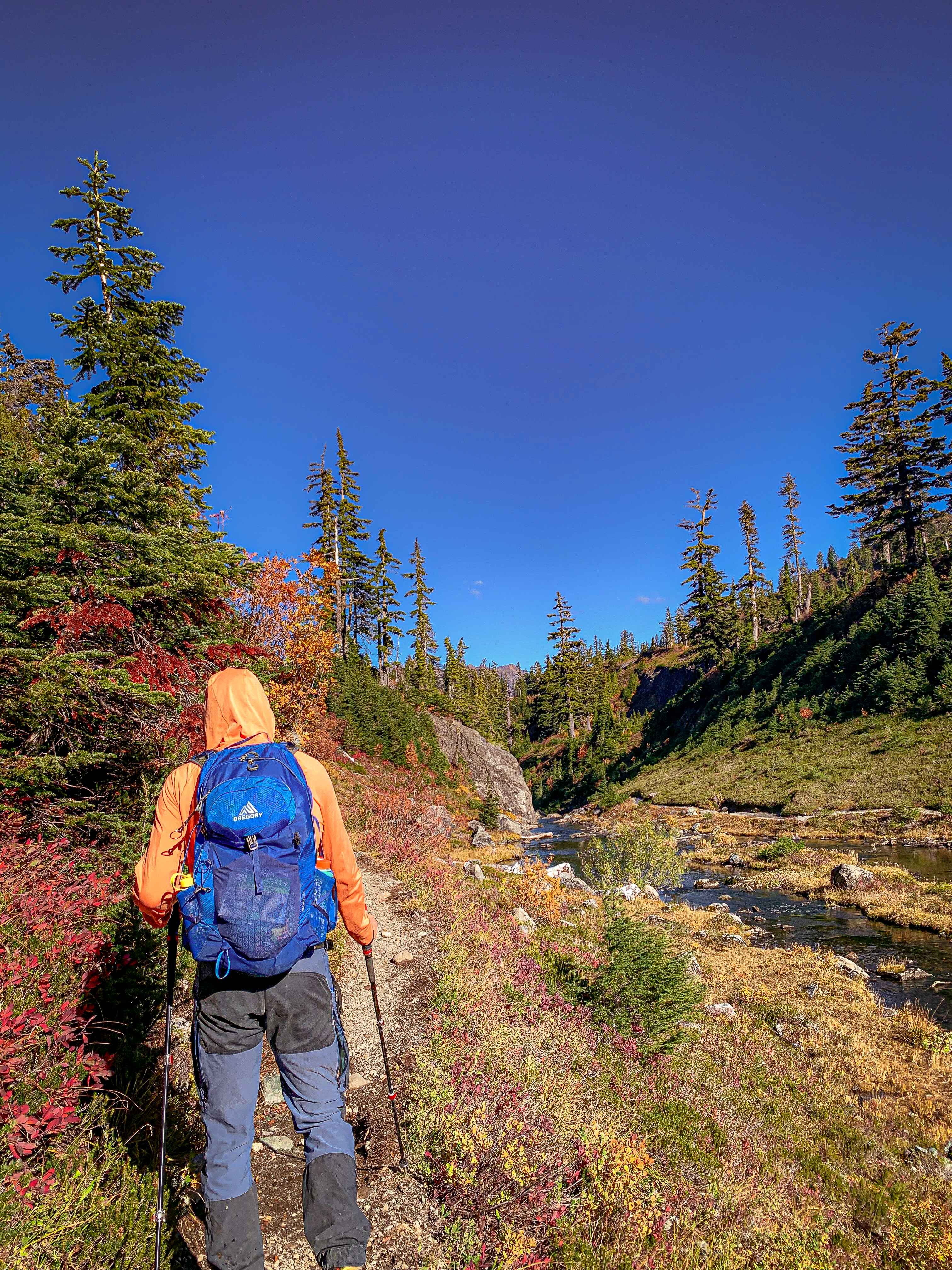 A day hiker with a backpack and sun hoodie in the North Cascades.