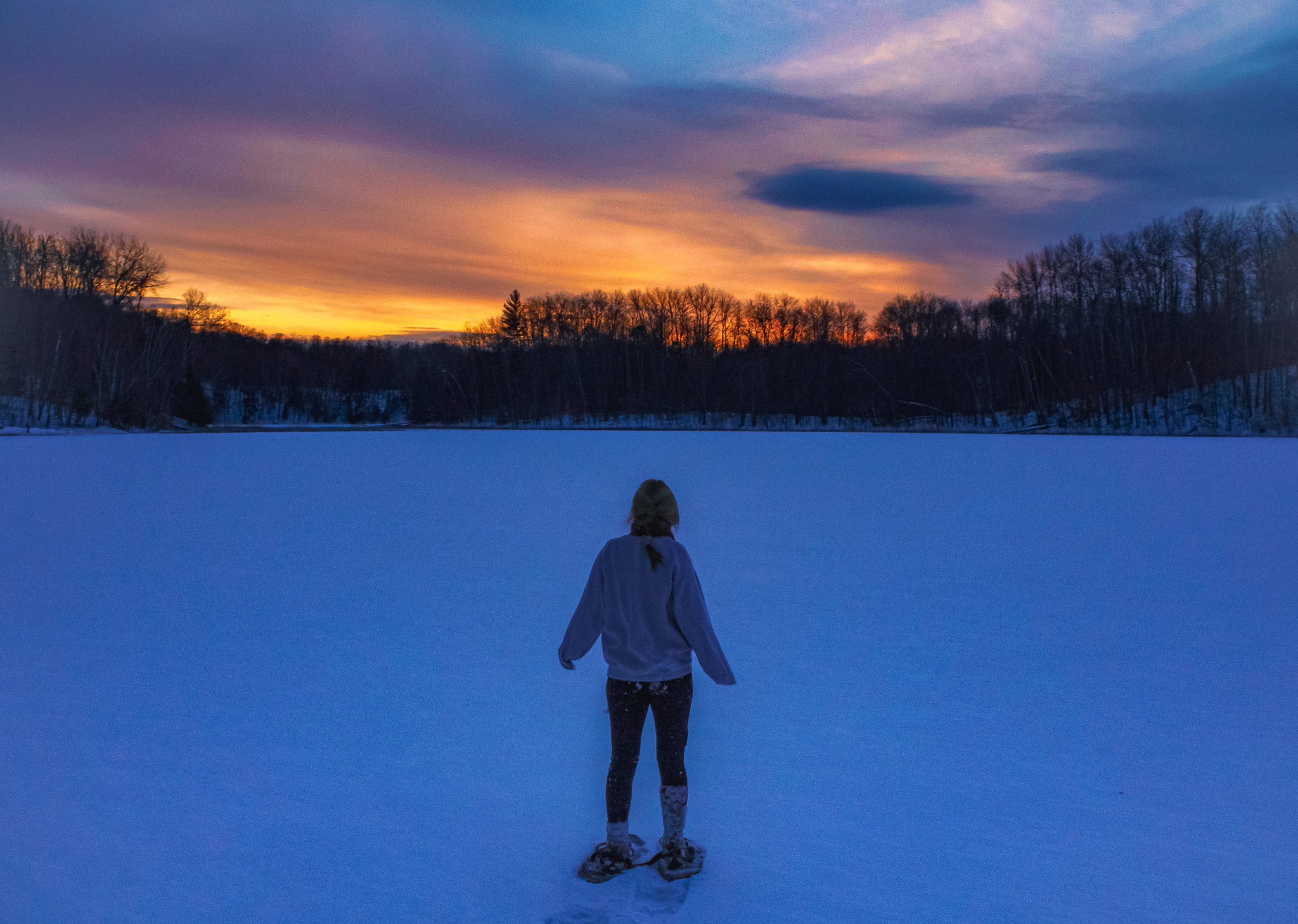 A snowshoer stands on a frozen Lake in Northern Michigan