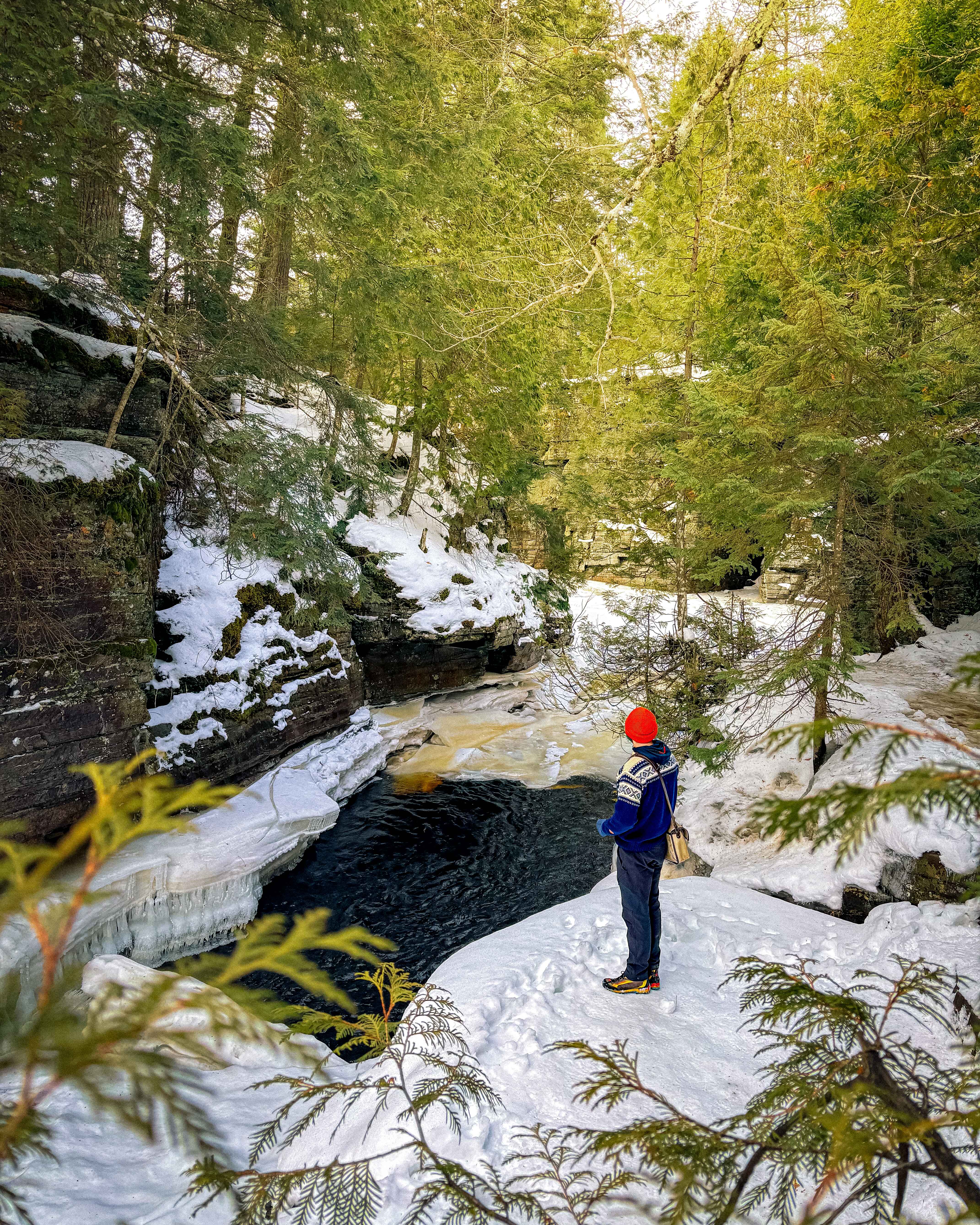 Image of a hiker standing in a wintery canyon at Canyon Falls in the Upper Peninsula