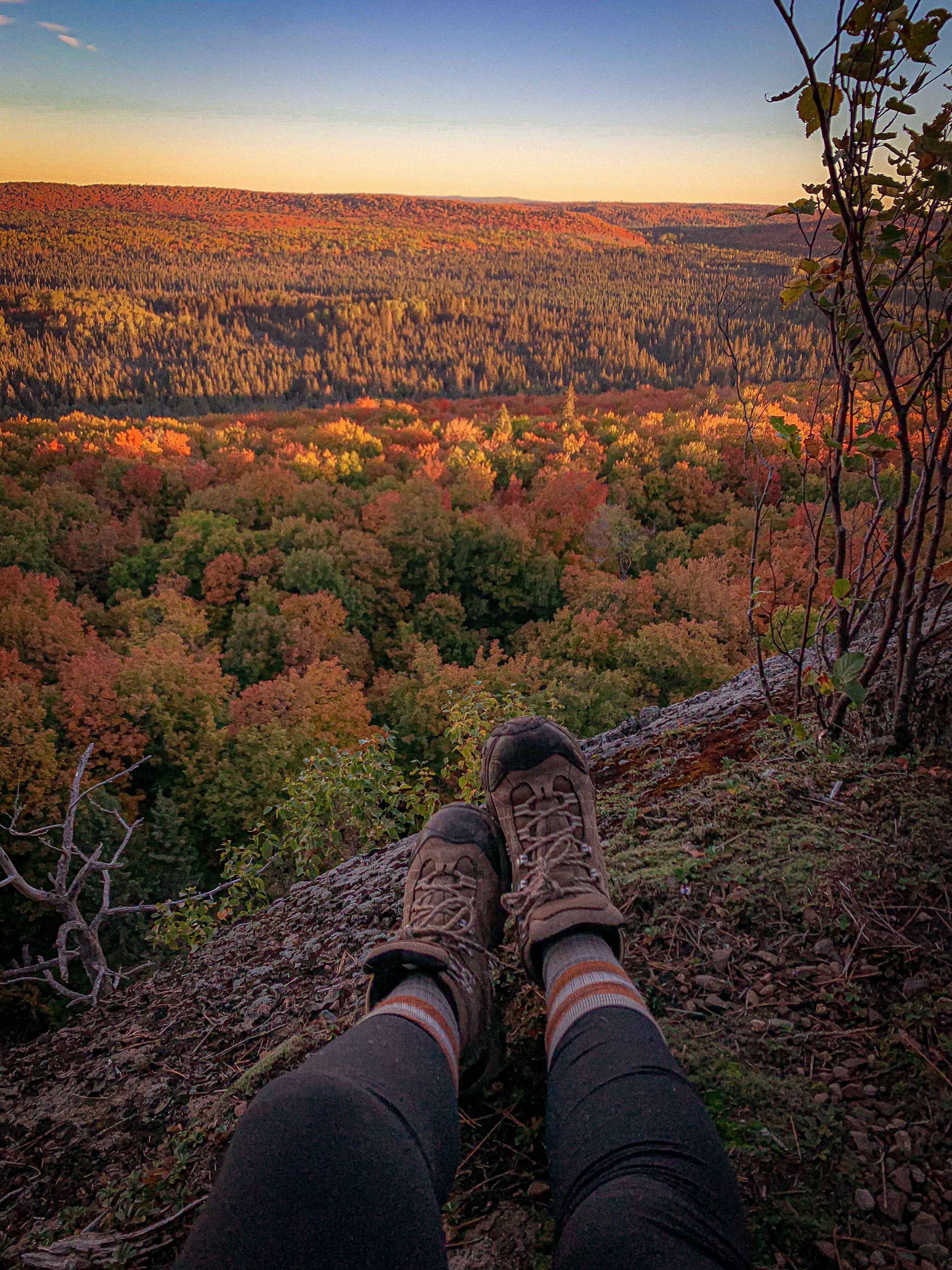 a hiker takes in the view from the Superior Hiking Trail in Minnesota