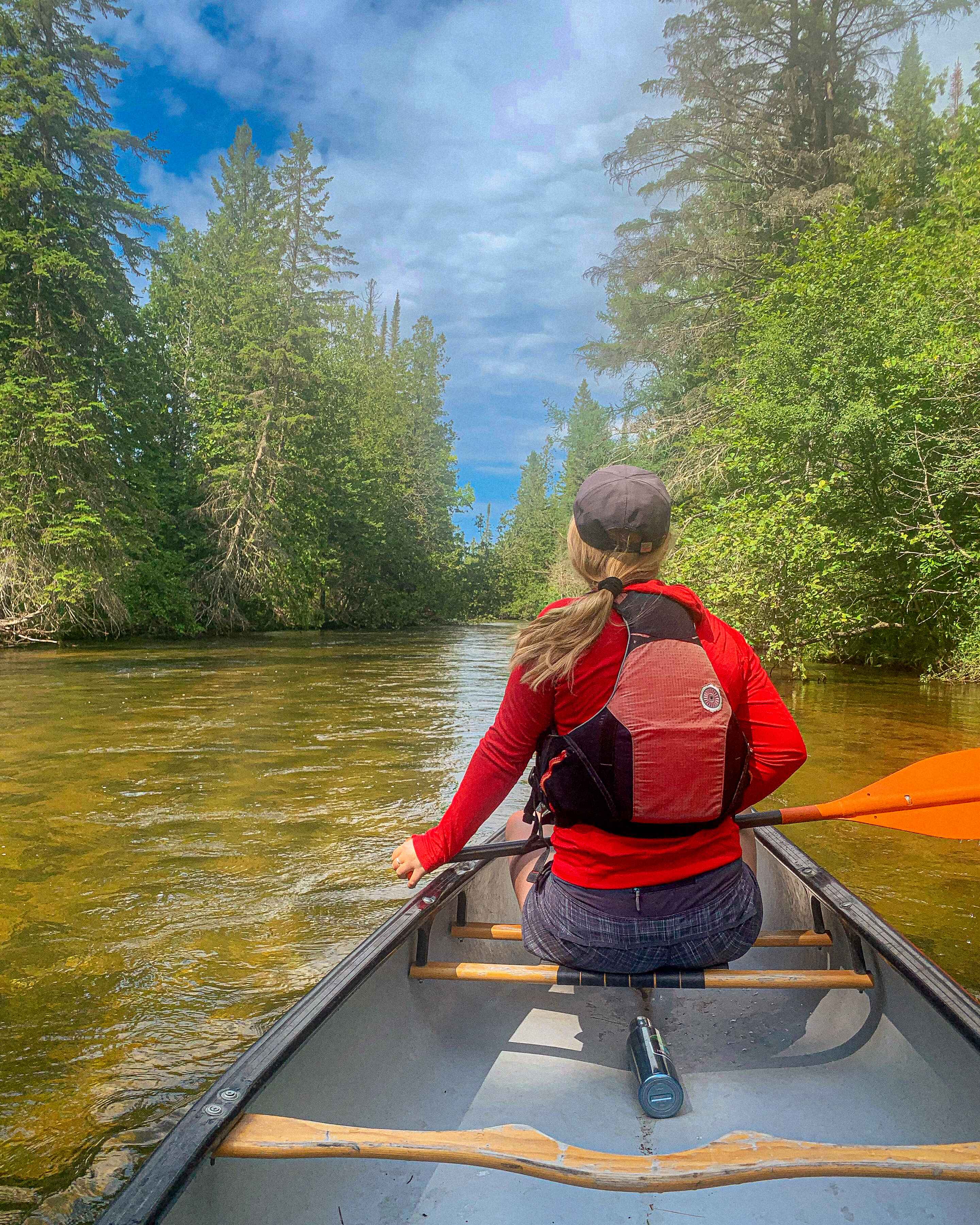 A canoer paddles the Jordan River, Michigan