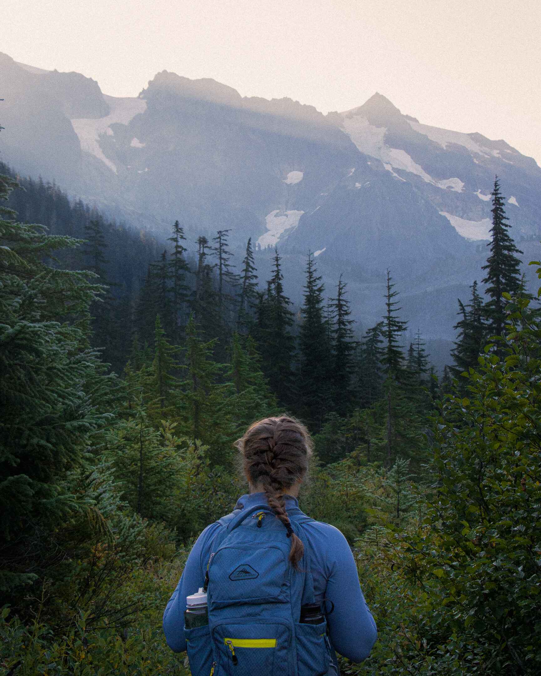 A day hiker wearing a fleece pullover and a backpack in the North Cascades