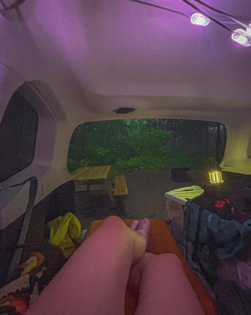 A hiker sets up car camping at a state park