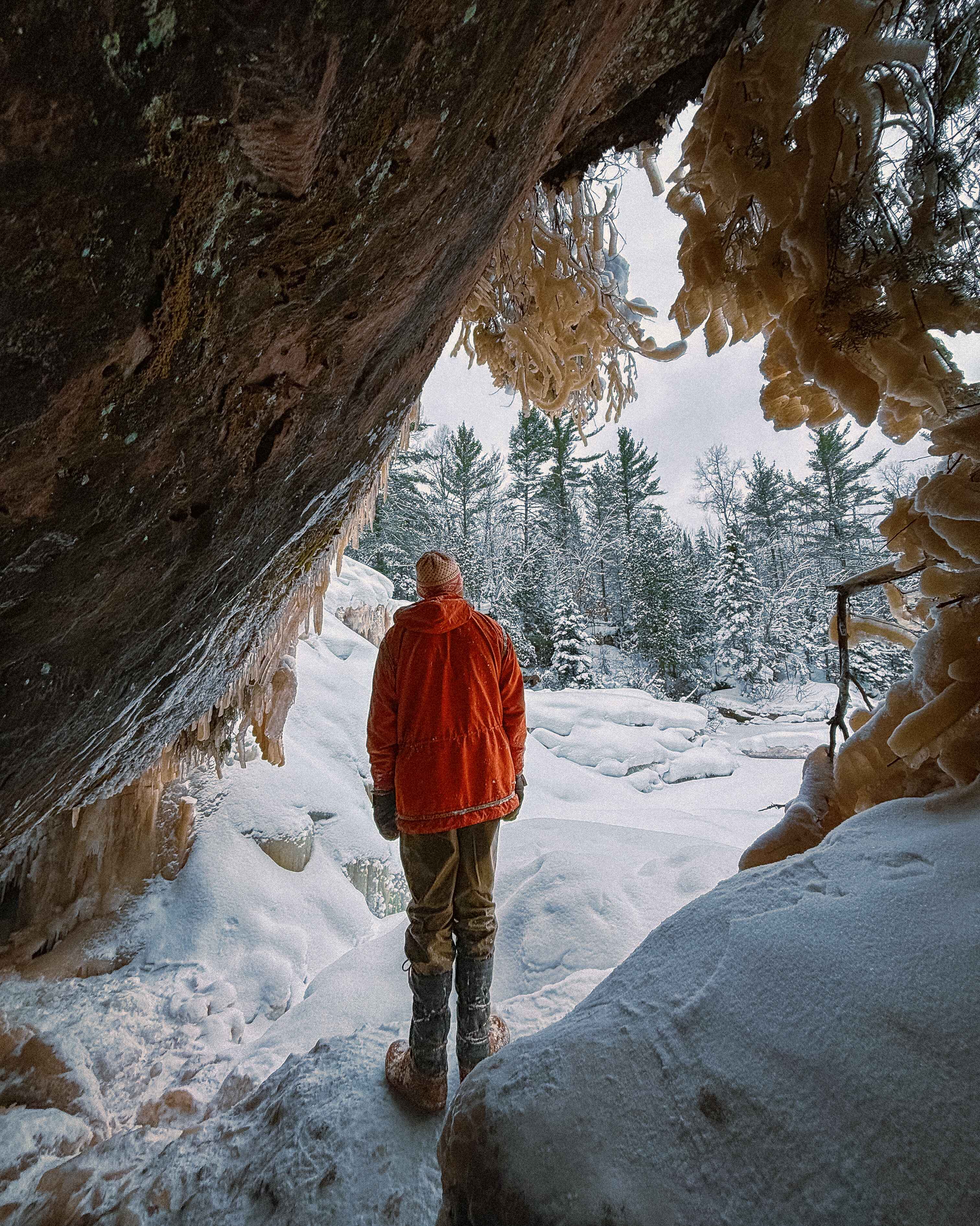 a hiker stands in an ice cave in the keweenaw peninsula