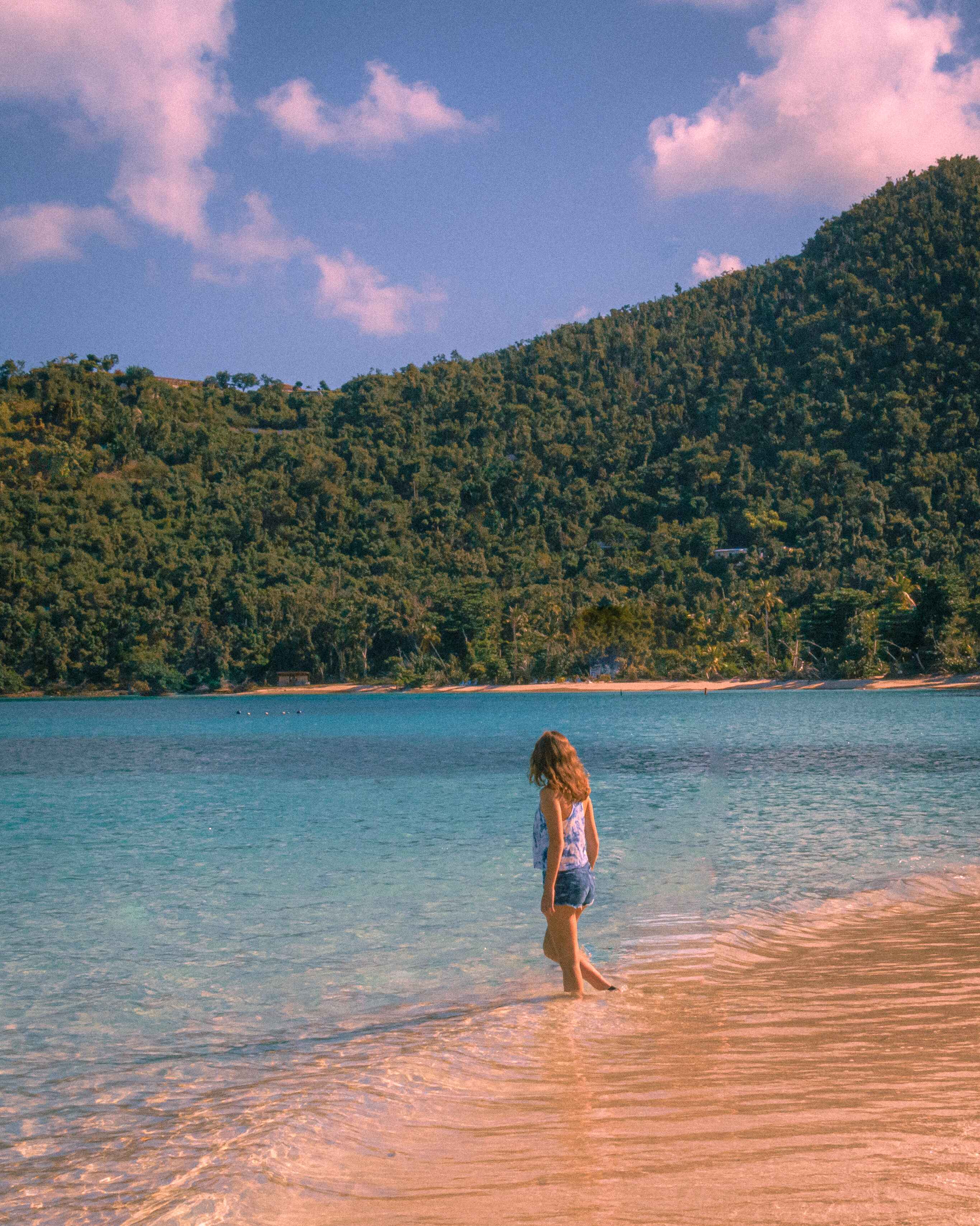 woman stands on a beach in virgin islands national park