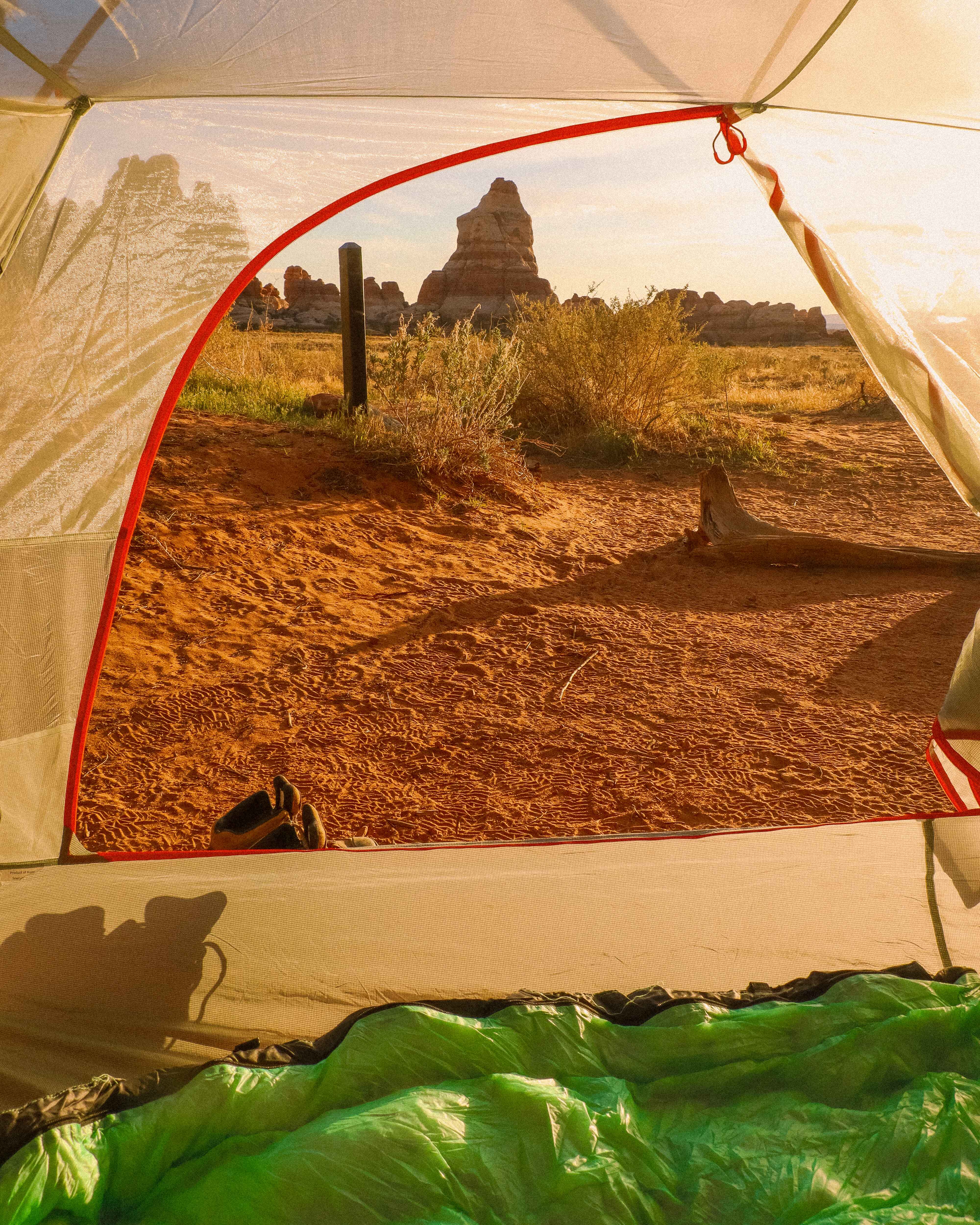 view out of a backpacking tent set up in the desert