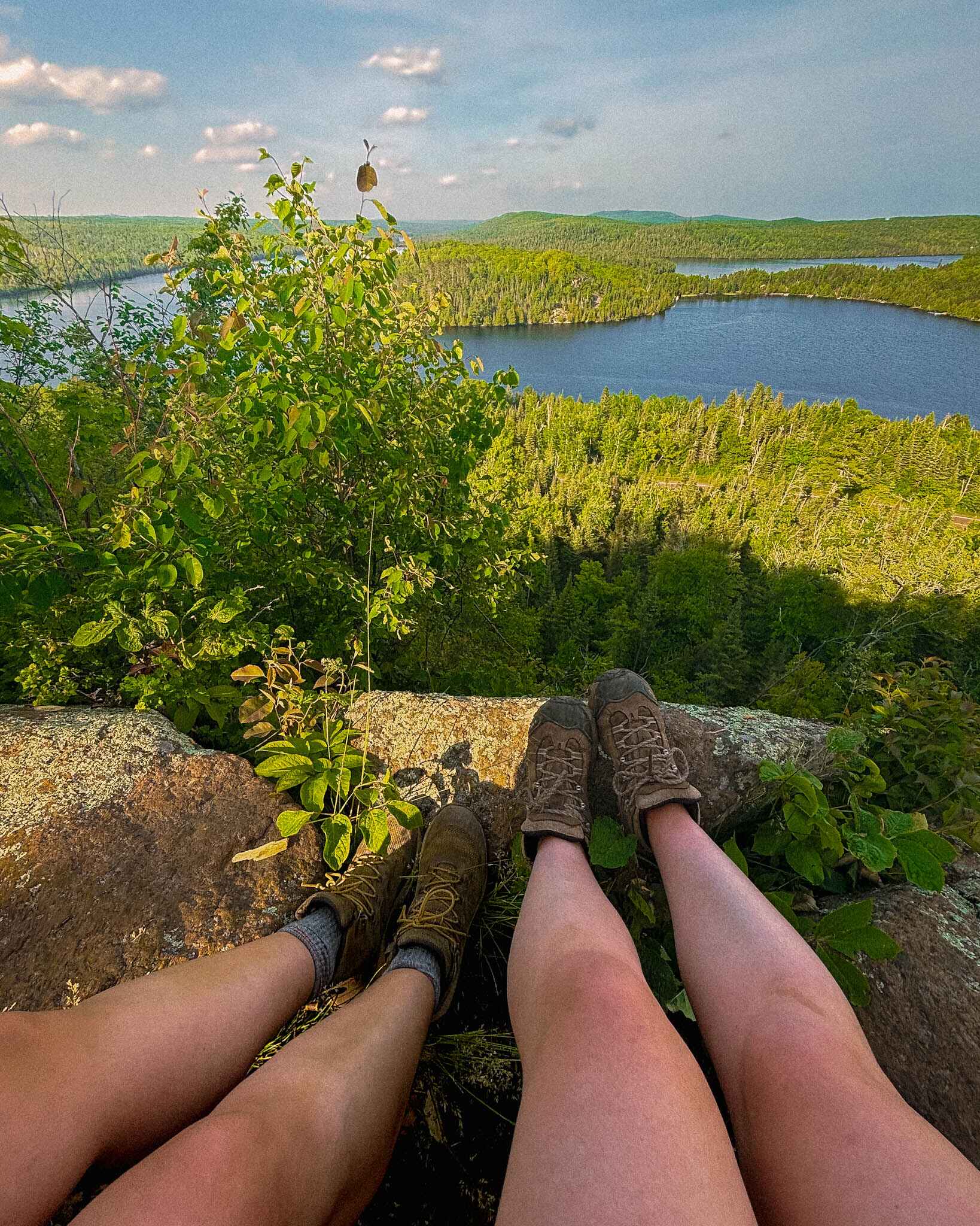 image of two hikers legs at an overlook on the north shore