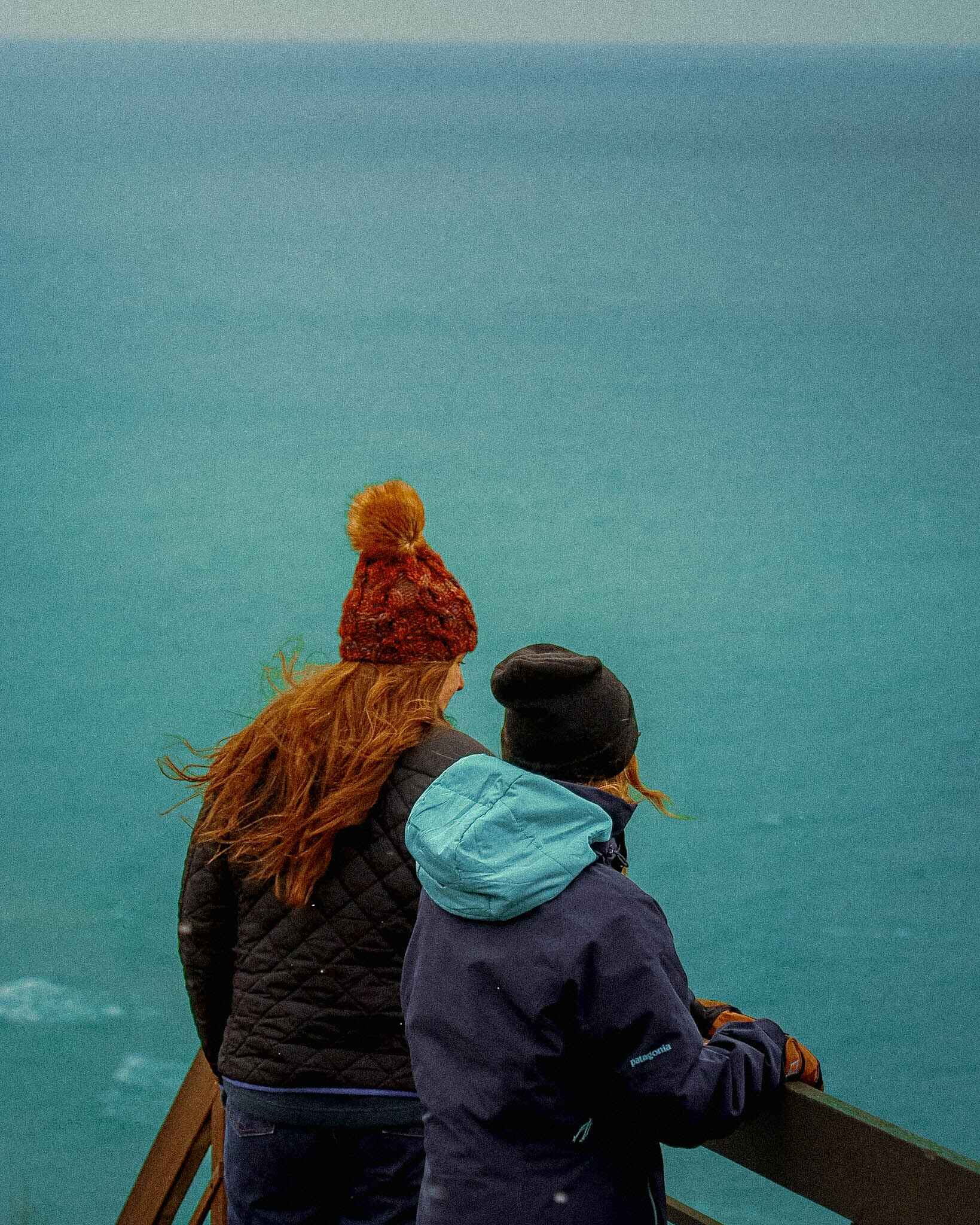 Hikers look out over the blue water of Lake Michigan from Inspiration Point 