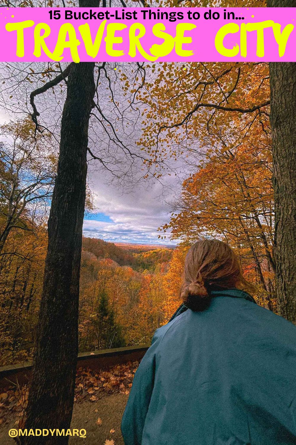 Image of a woman hiking near traverse city surrounded by peak fall color with text "best things to do in traverse city michigan" written over the top of the image