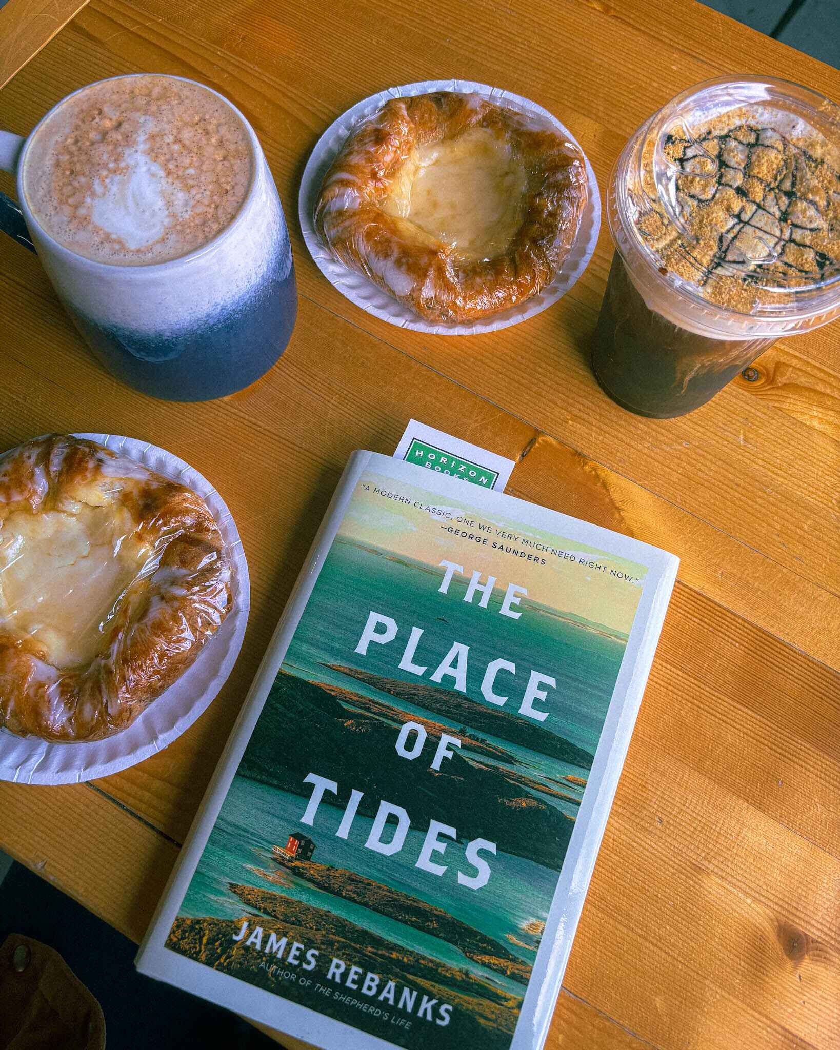 Coffee, cream cheese danishes and a book from Traverse City's Horizon Bookstore sit on a coffee table in Espresso Bay, downtown Traverse City
