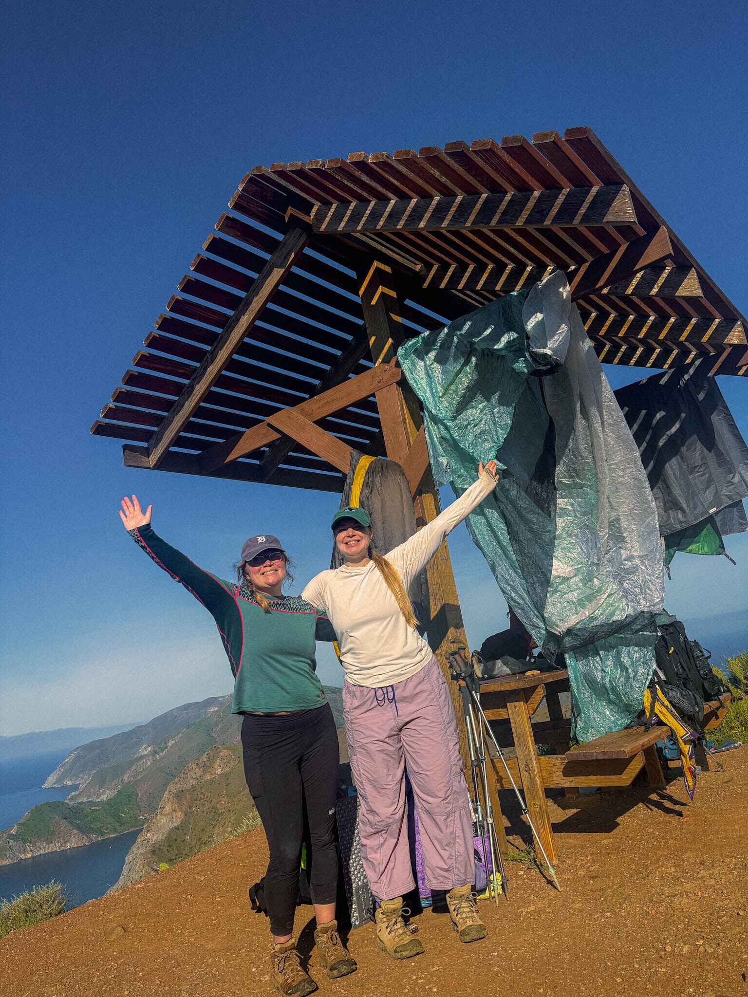 two backpackers pose at a rest stop on the transcatalina trail