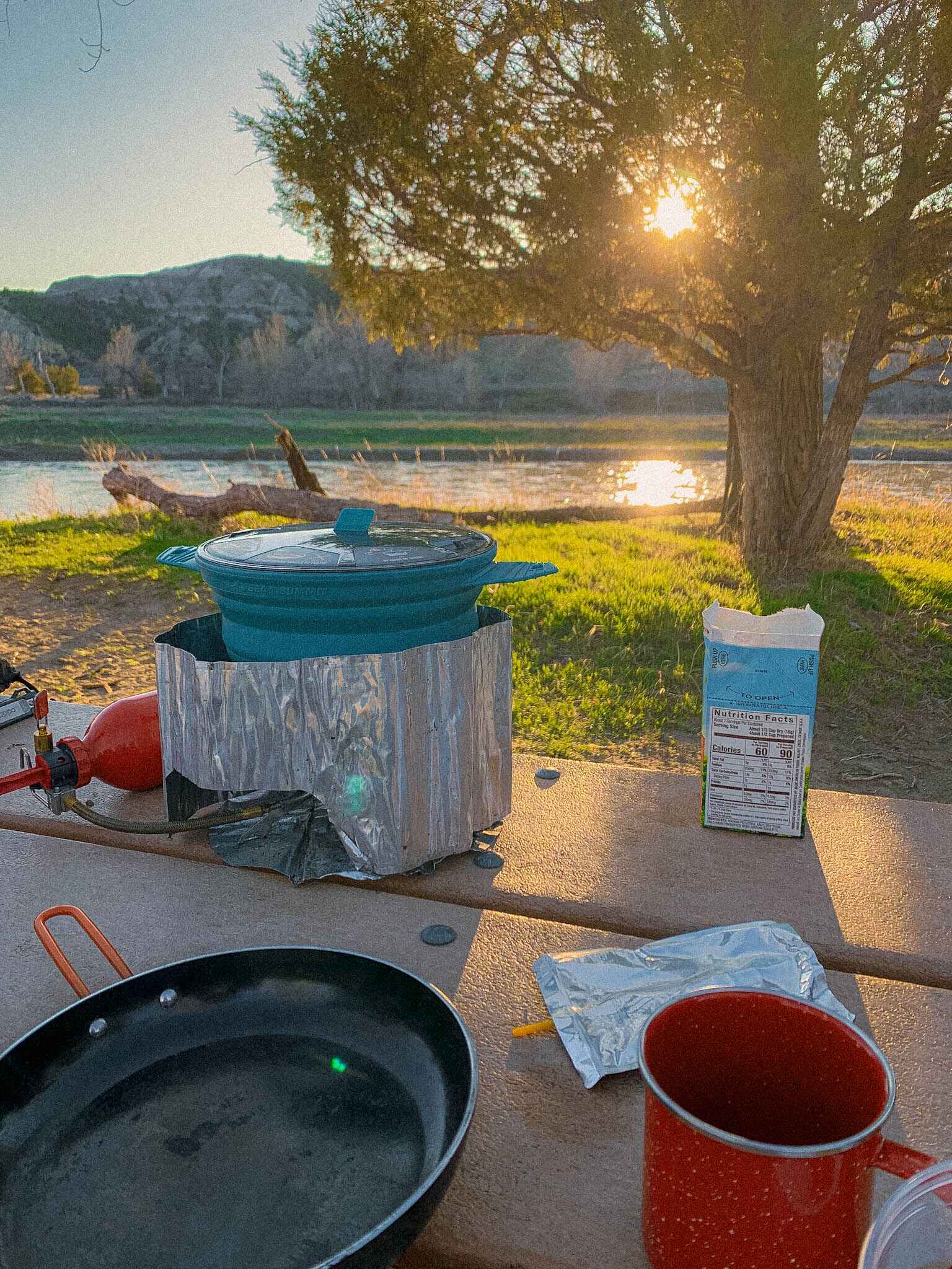 image of a whisperlite stove at a rivers edge
