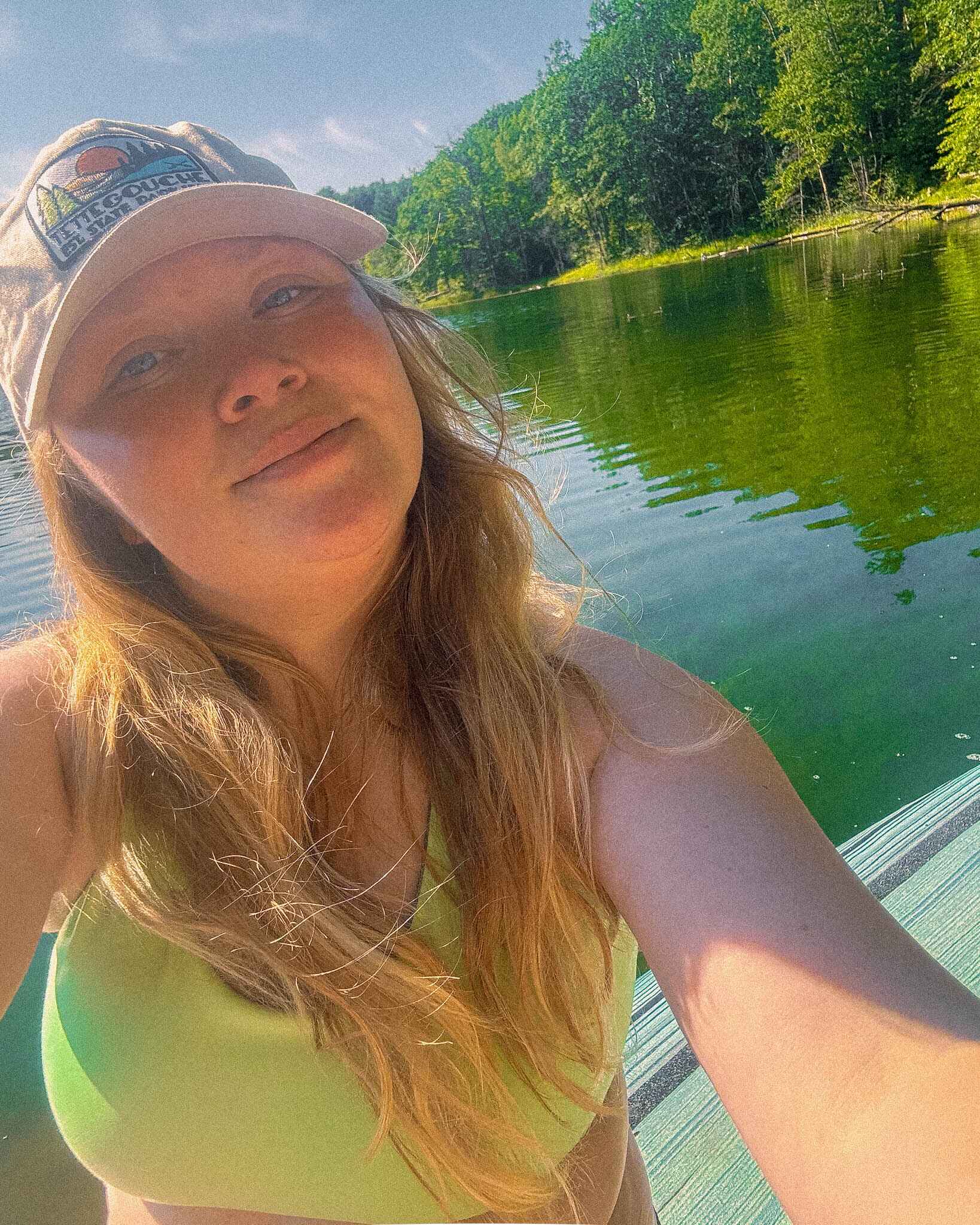 Selfie of a woman on a paddleboard in a Tera Kaia sports bra