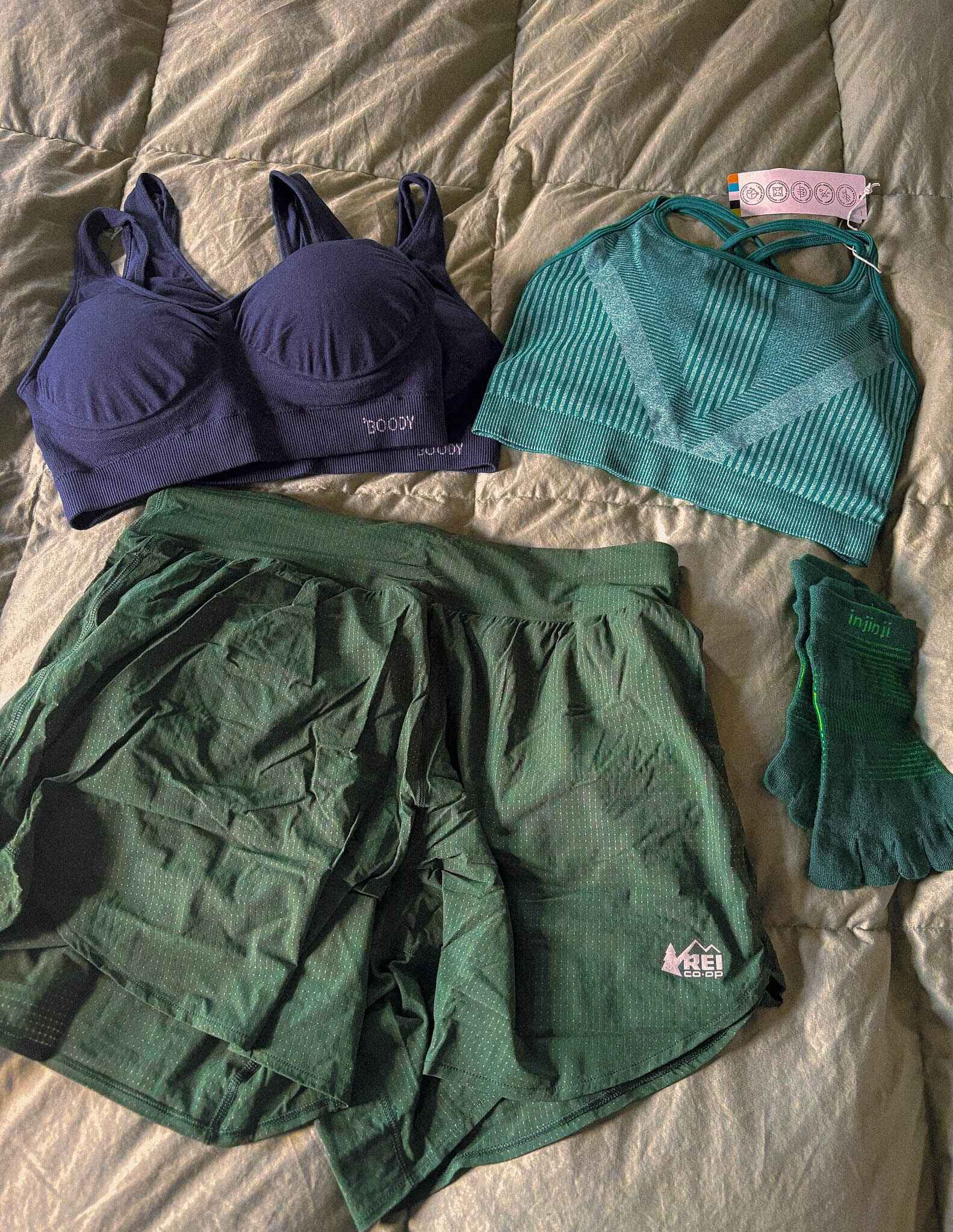flat lay of sports bras and a pair of hiking shorts