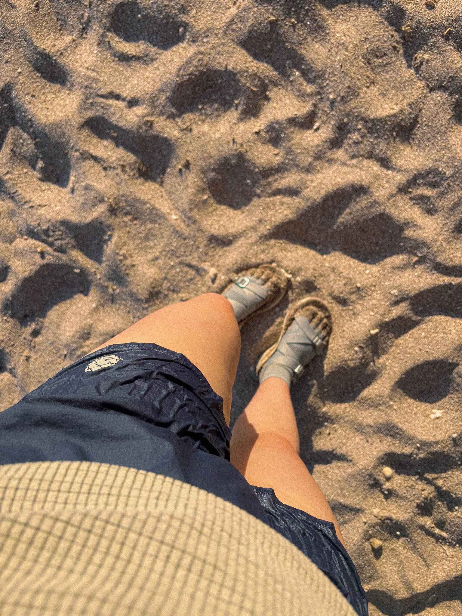 a pair of wet hiking shorts on a hiker in the sand
