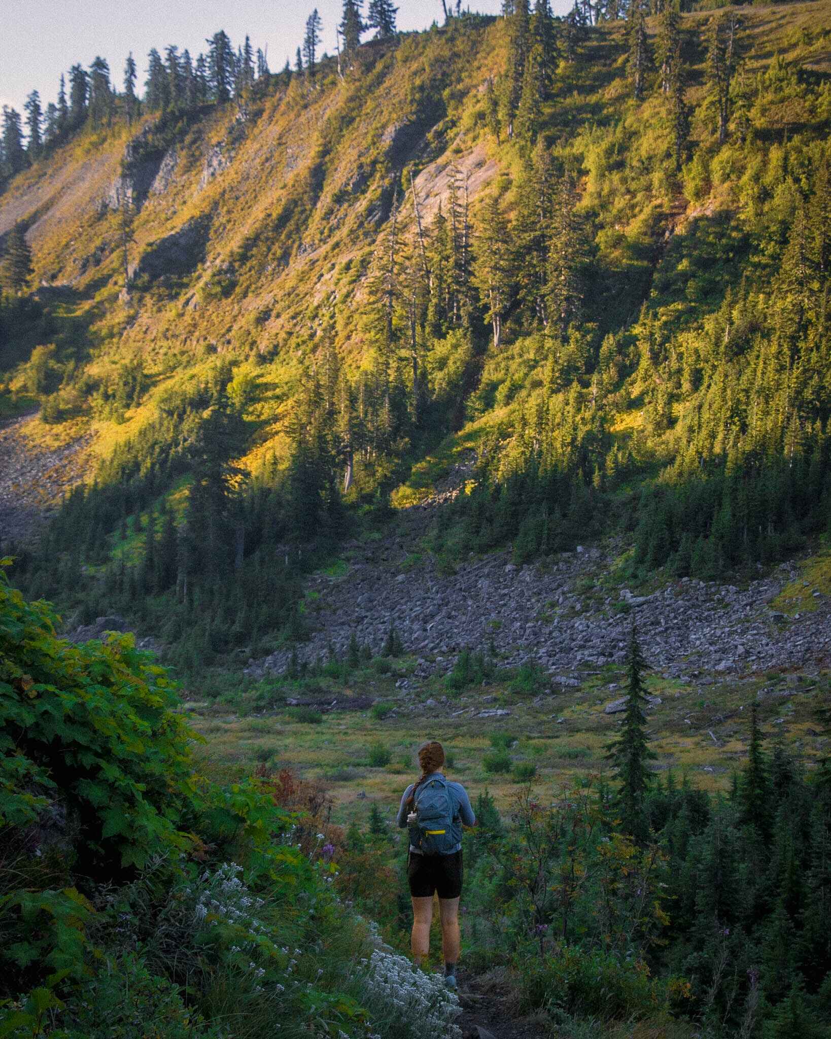 A hiker in a valley in legging style hiking shorts
