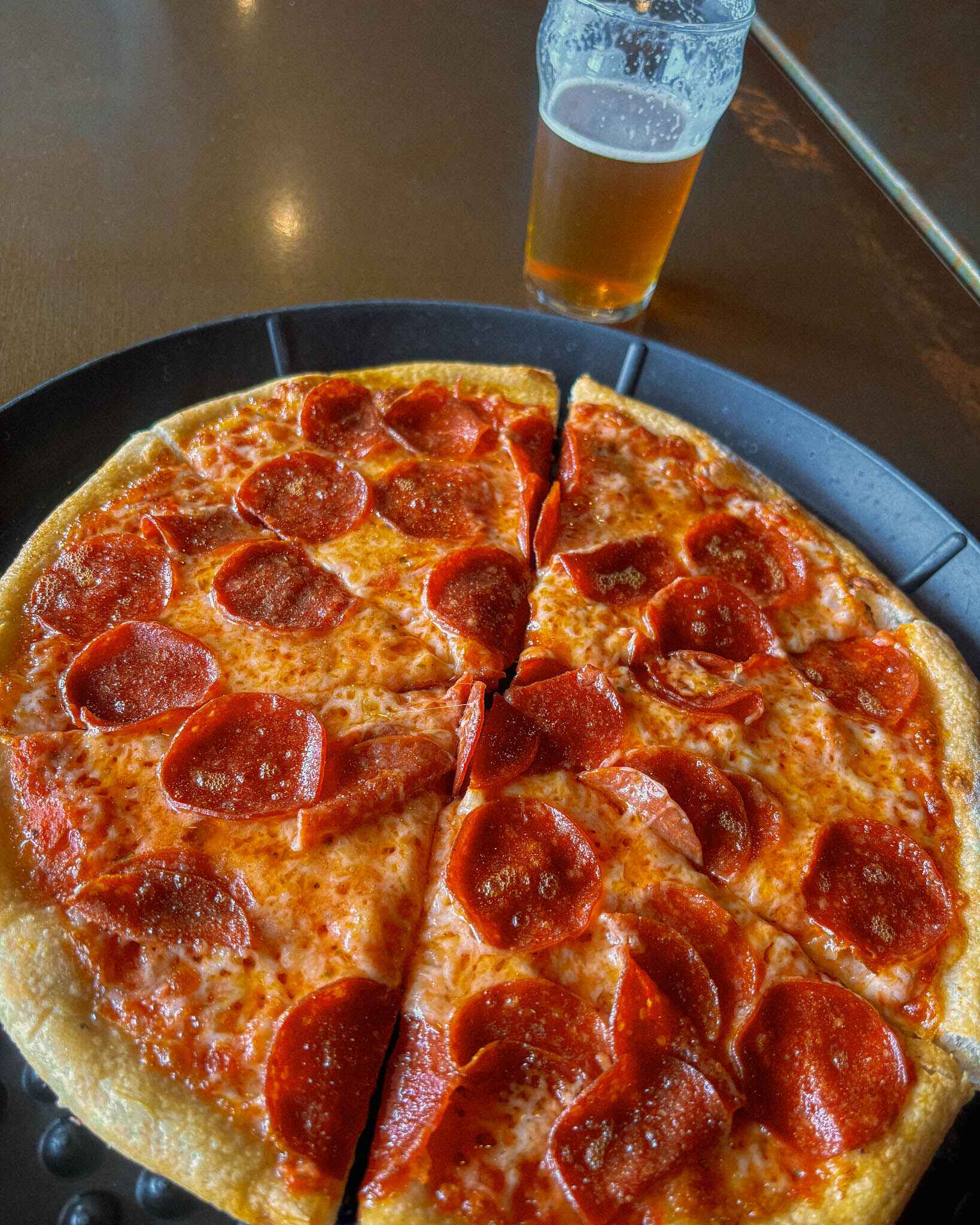 image of wood fired pizza and a beer at ABC brewing in Battle Lake, Mn