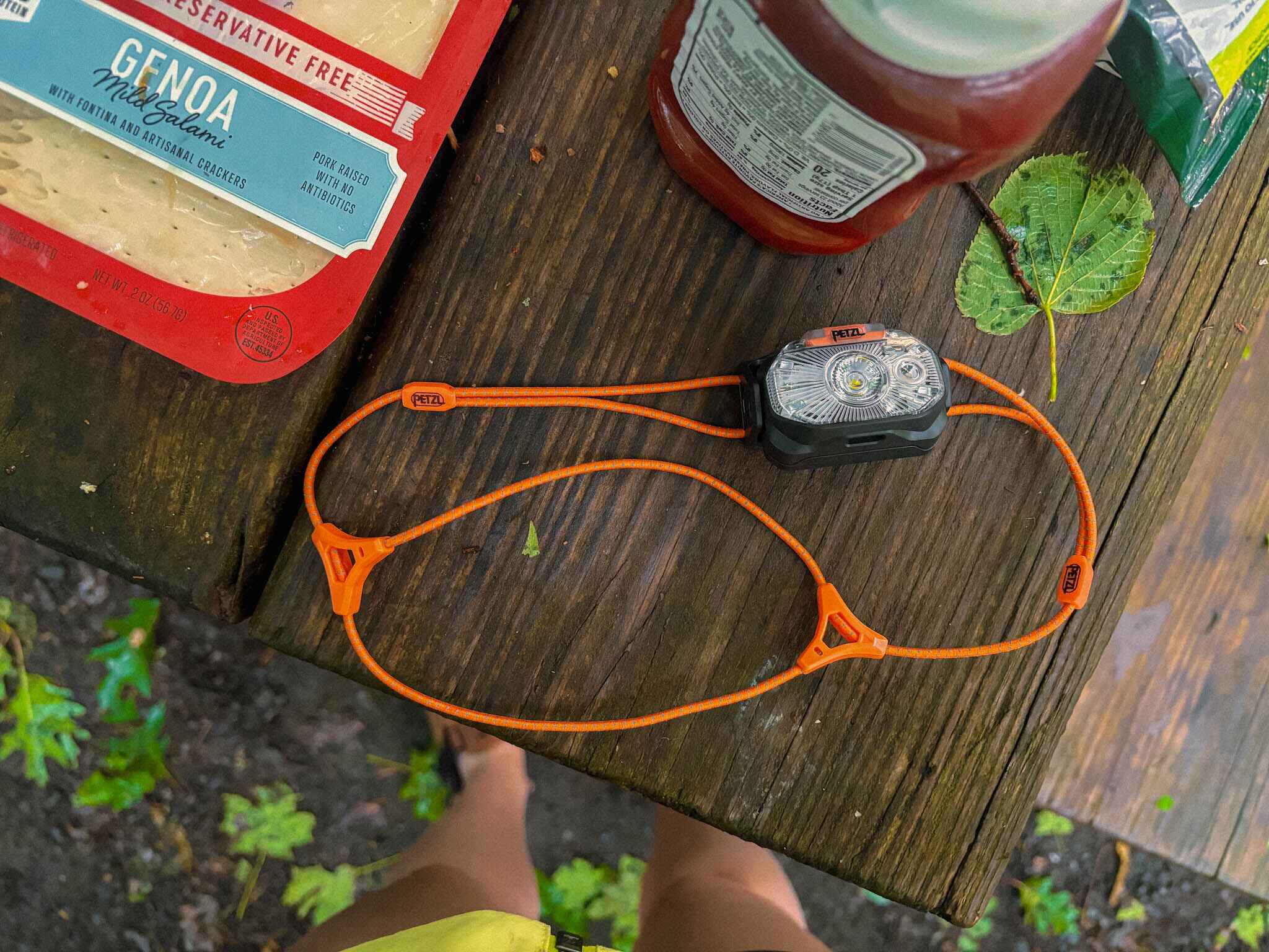 best ultralight headlamp for camping and backpacking - petzel LT on a camping picnic tabel