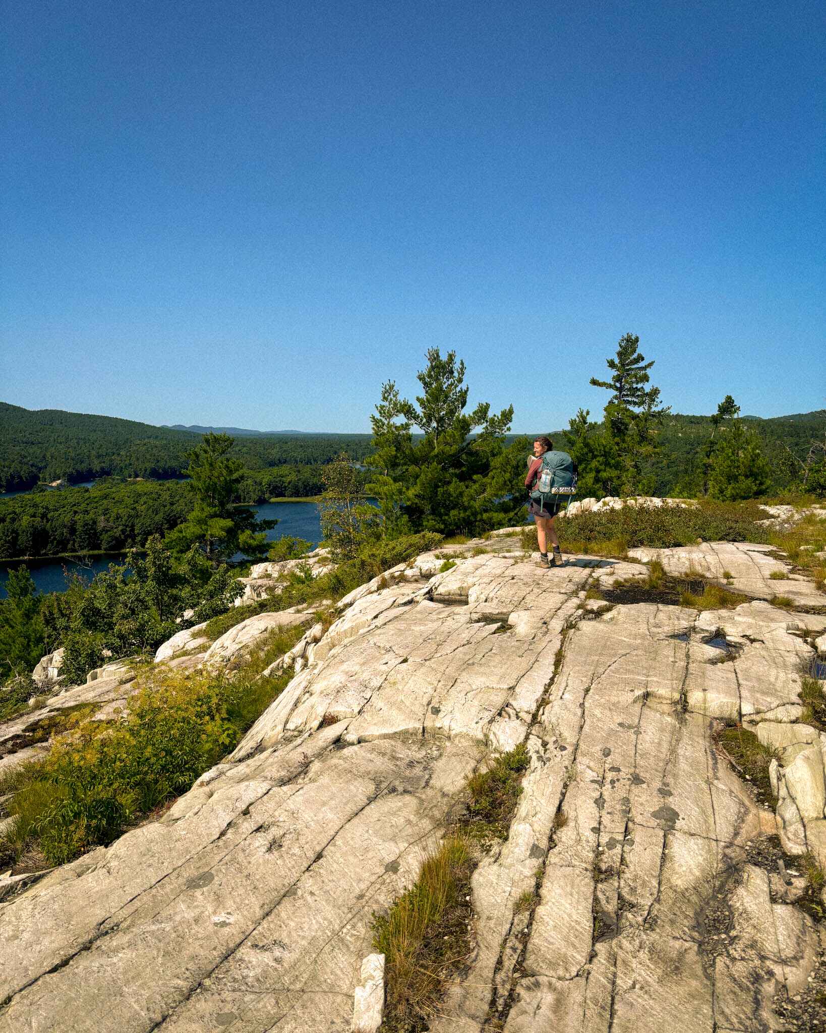A backpacker on a granite ridge in Killarney