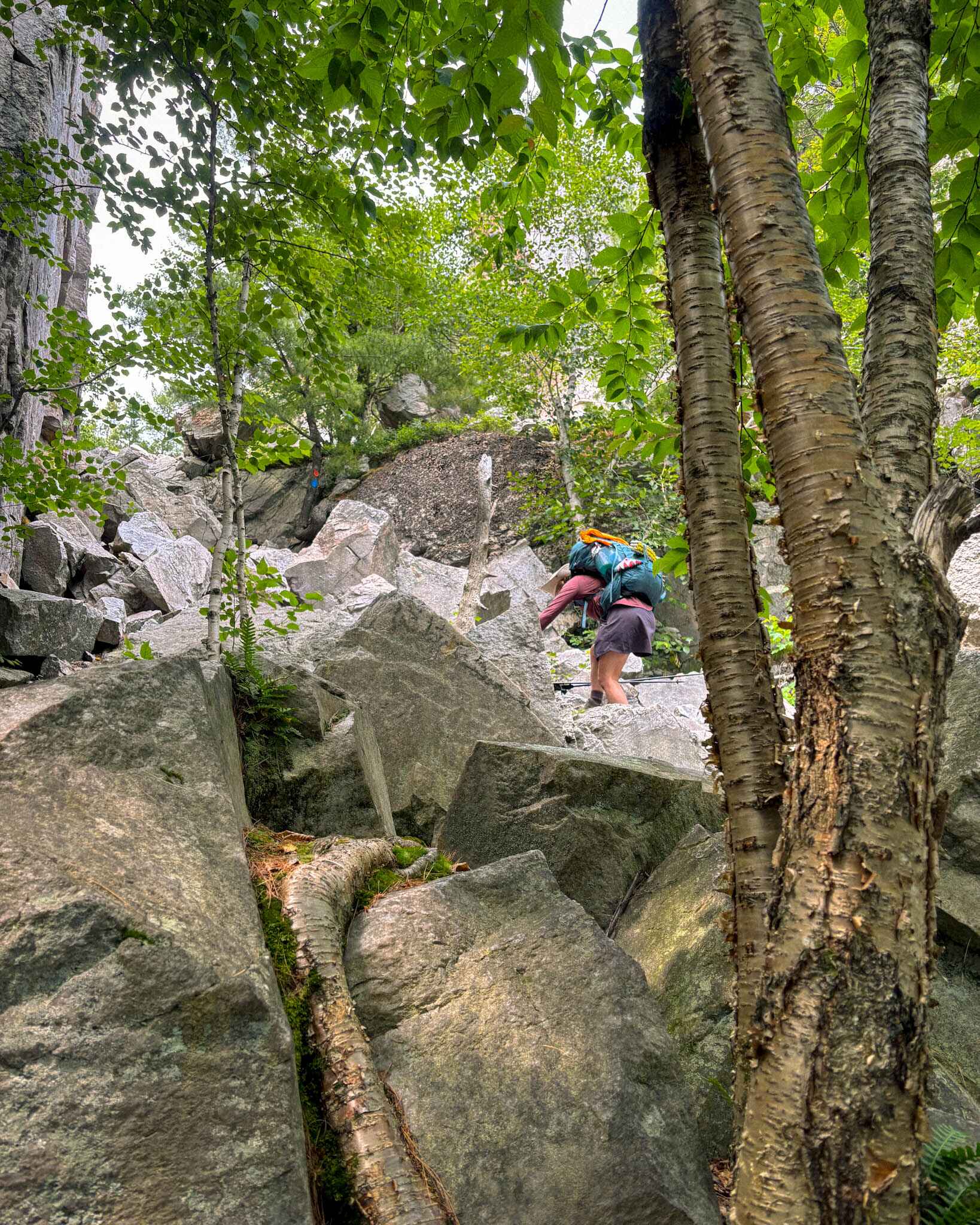 Backpacker climbs up the Crack in Killarney Provincial Park, Ontario