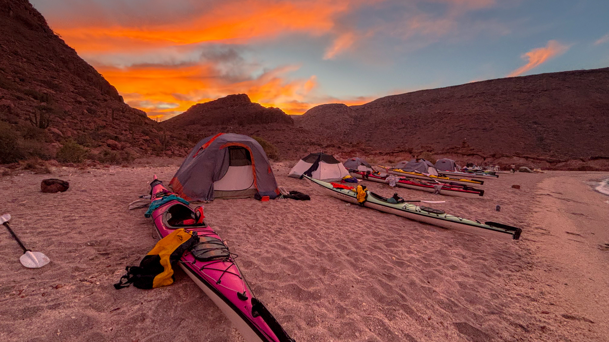 image of sunrise over a kayaking campsite in Baja California
