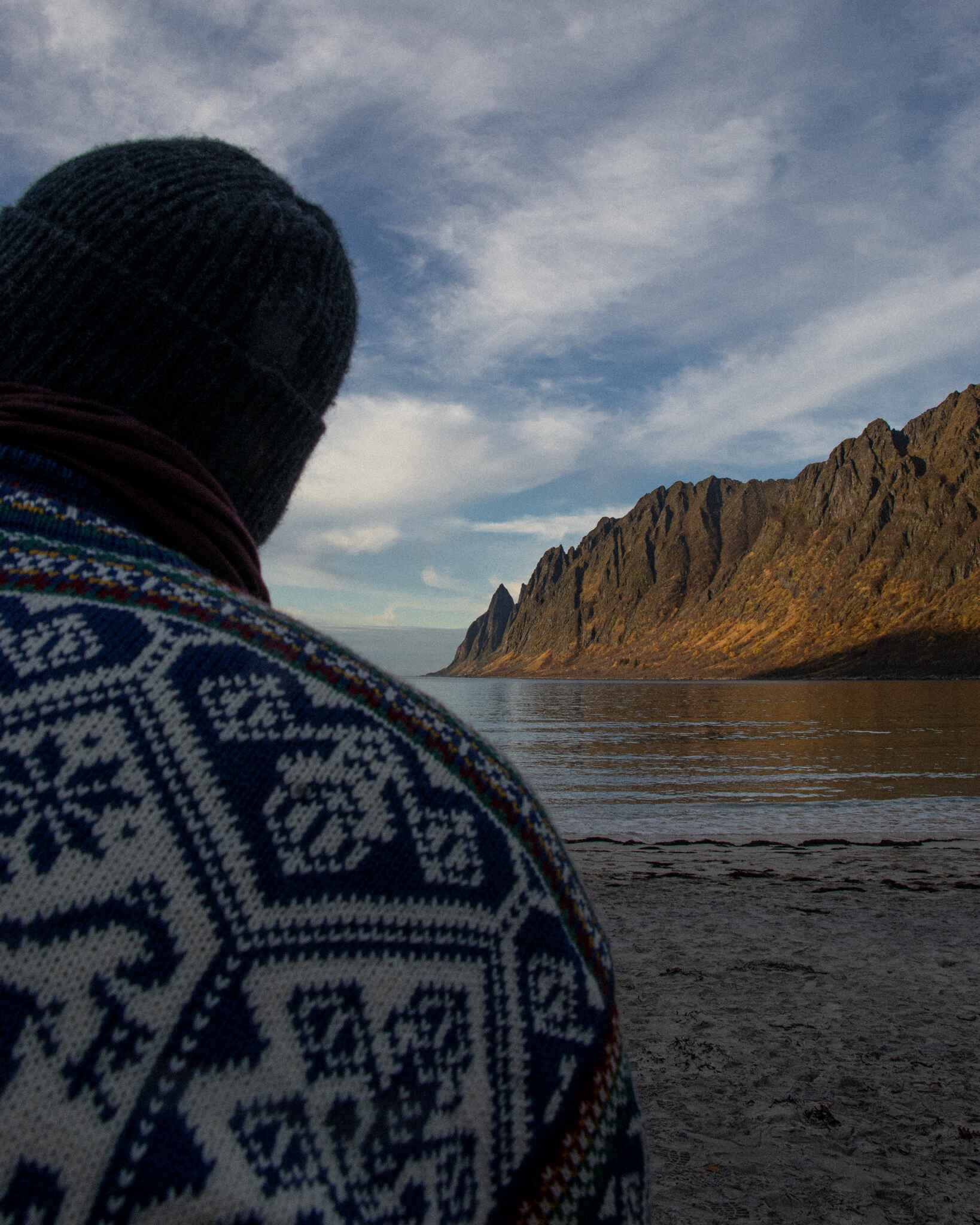 Image of a man in a Norwegian sweater at Ersfjord beach
