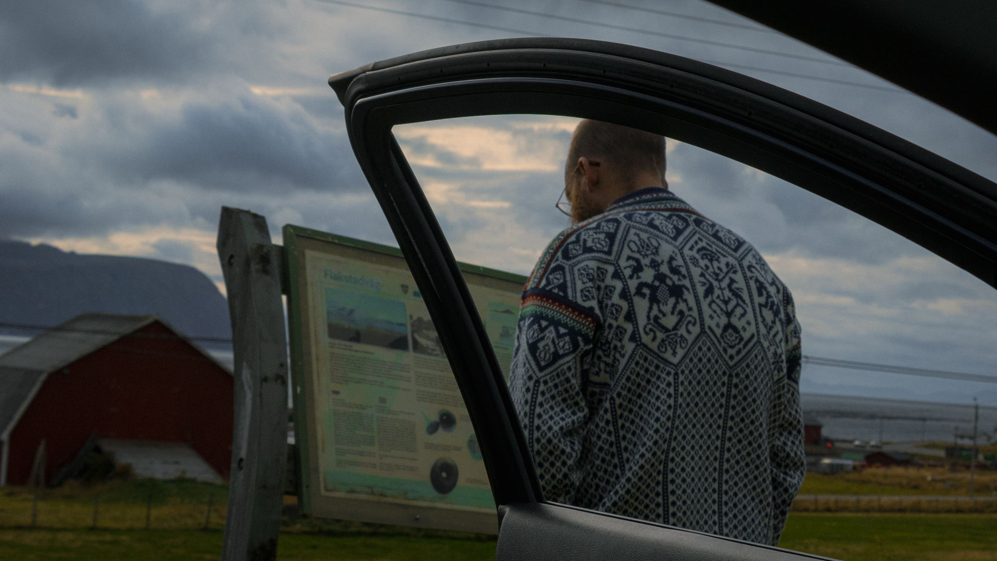 Image of a man framed by an open car door