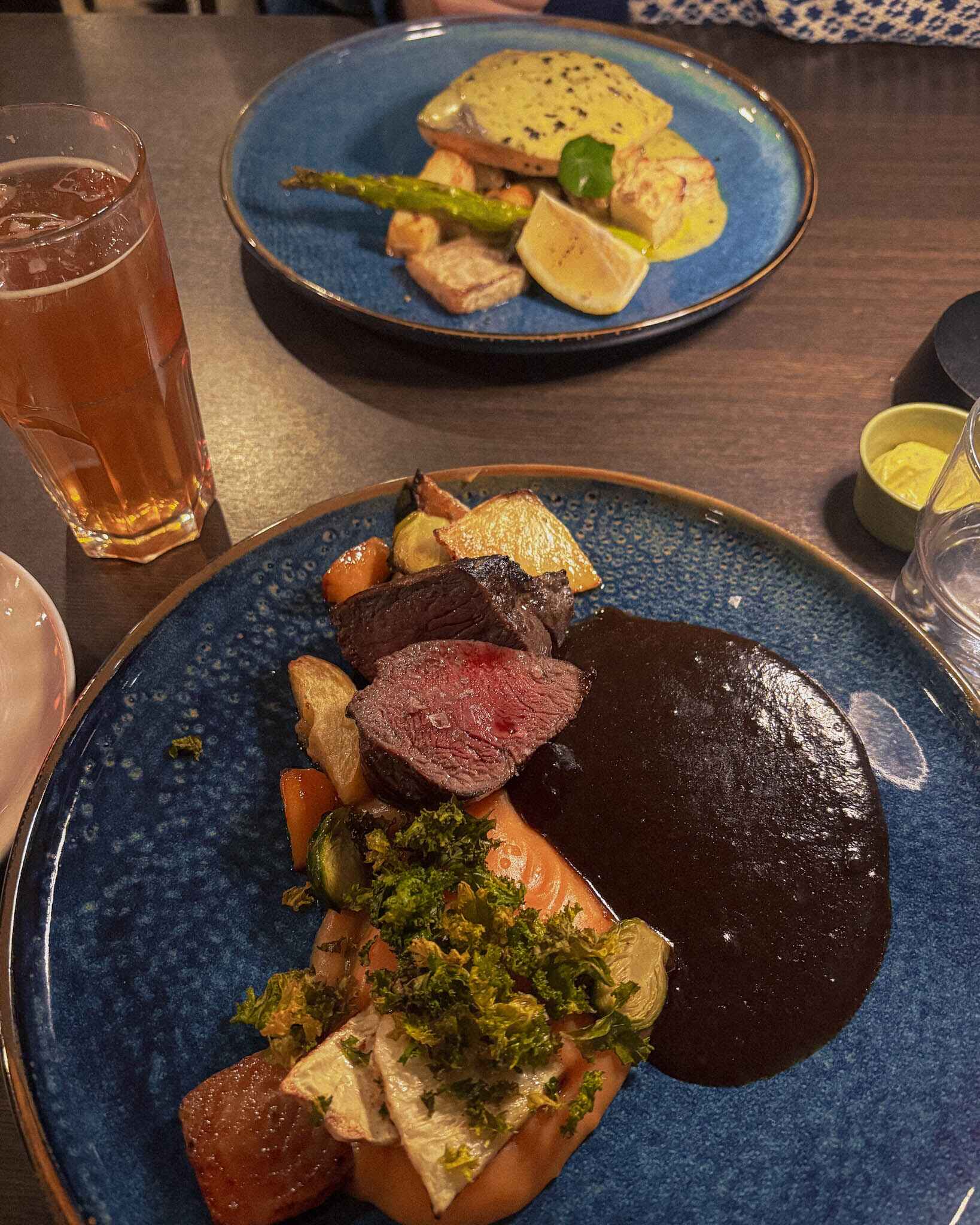 image of dinner at storbrygga restaurant on senja island; a reindeer steak and sea trout