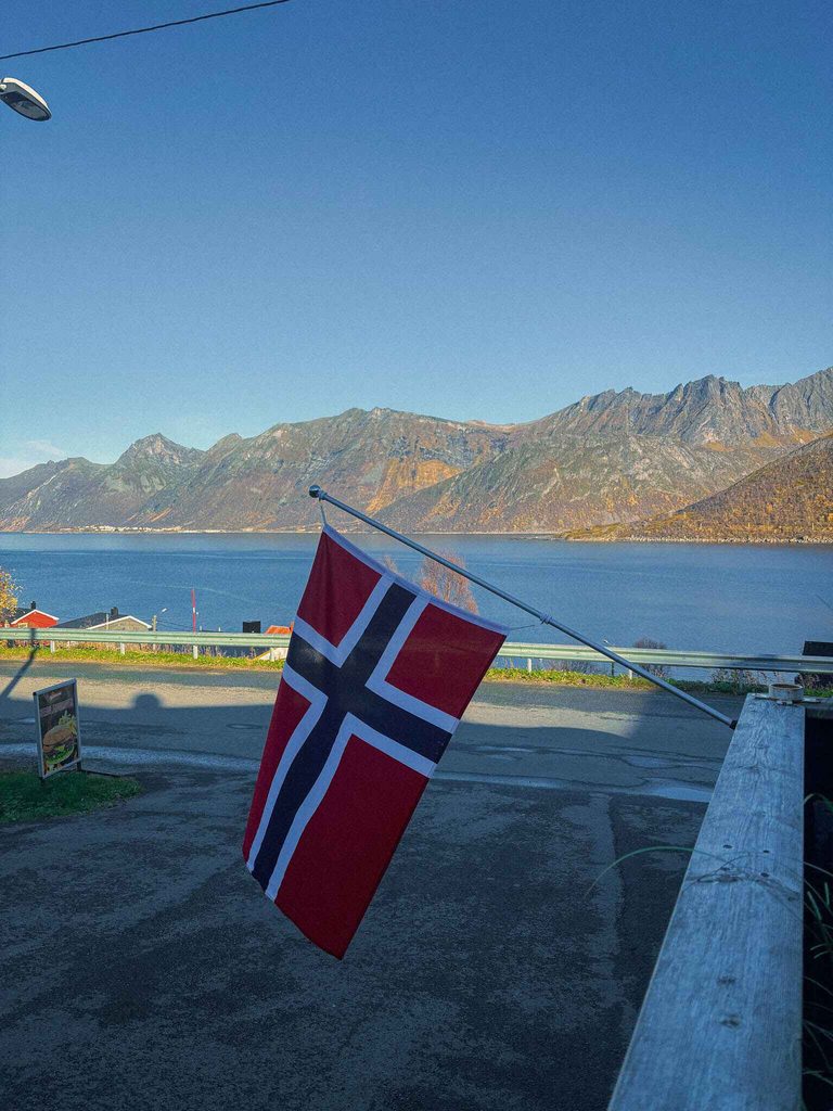 A Norwegian Flag hangs outside of Selga Grill and Pub on Senja Island, Norway